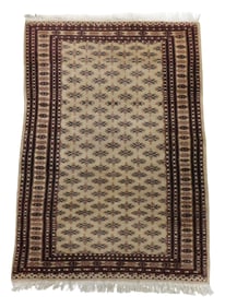 RUG: Modern Bokhara rug, 5' 10" l. x 4' w., tan ground with maroon and brown details, minor soiling,