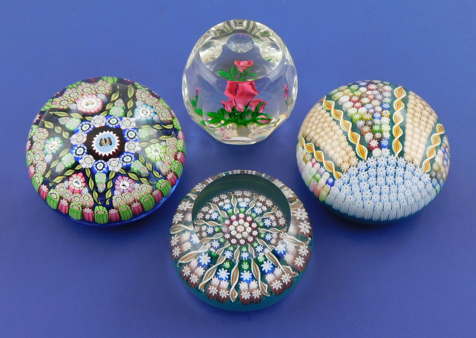 ART GLASS: Four Perthshire studio glass paperweights, Scotland, including: Millefiori style: ART GLASS: Four Perthshire studio glass paperweights, Scotland, including: Millefiori style paperweight, C. 1990’s, patterned multicolor sunrise design, clear orb with teal ground, 2” h x 3&rd
