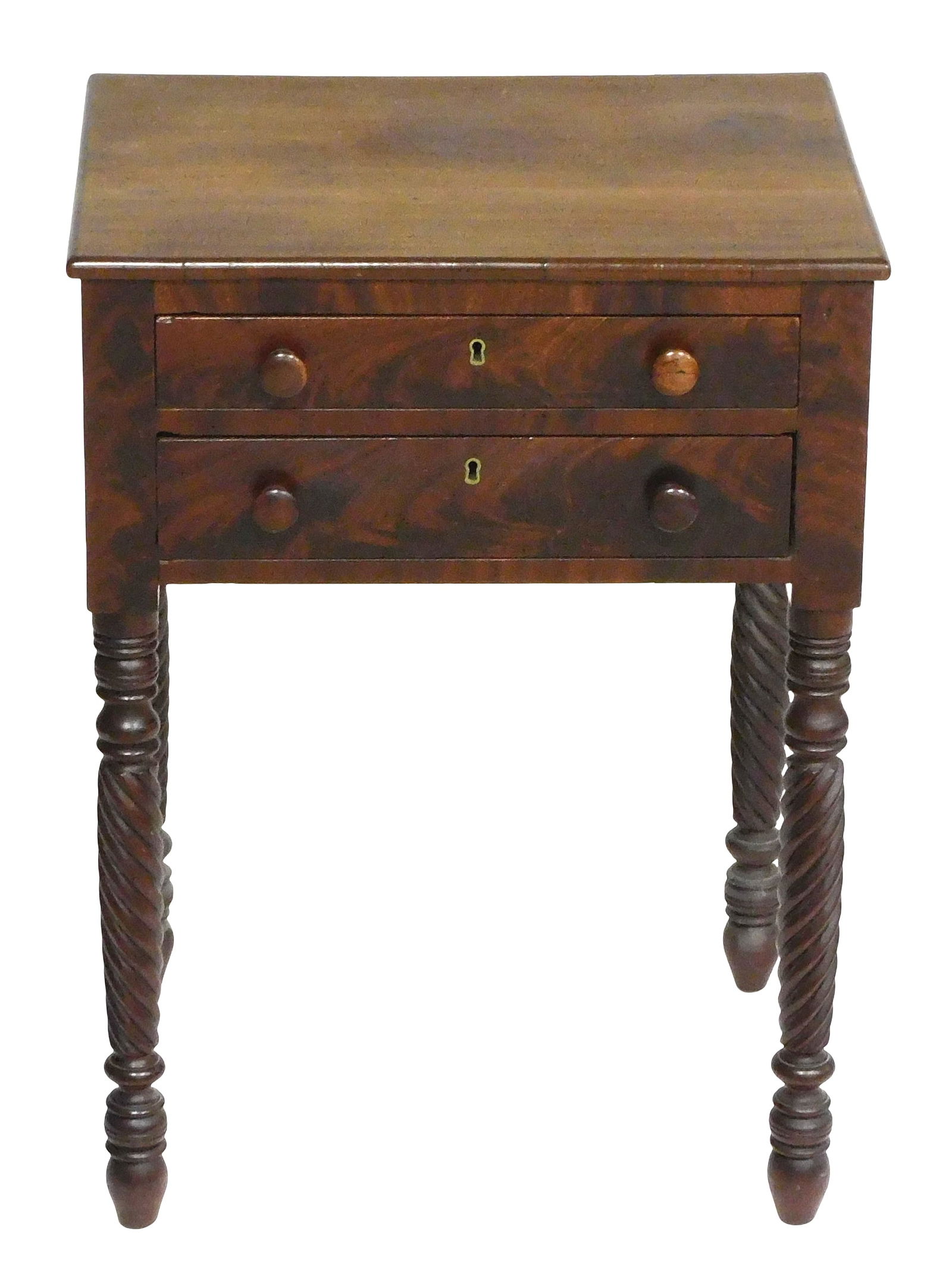 +Two drawer stand, American, c.1825, mahogany and mahogany veneer, drawers and front with crotch ven: +Two drawer stand, American, c.1825, mahogany and mahogany veneer, drawers and front with crotch veneer, wood knobs, over vase and rope turned legs ending in ring turned tapered feet, refinished, chip