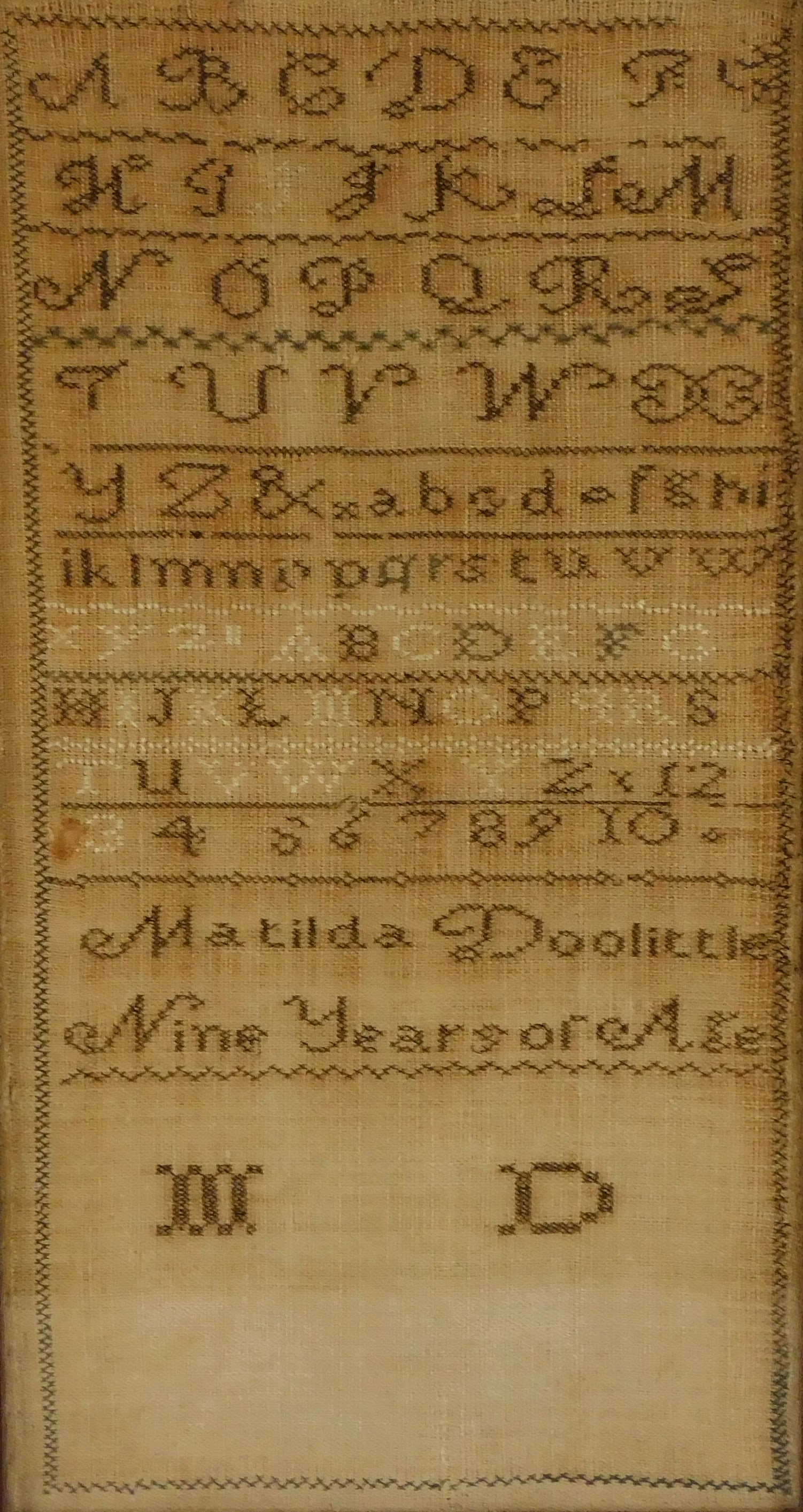 SAMPLER: 19th C. Band sampler by Matilda Dolittle, nine years of age, silk on linen, alpha numeric,: SAMPLER: 19th C. Band sampler by Matilda Dolittle, nine years of age, silk on linen, alpha numeric, framed behind glass with label verso of family provenance, scattered loss, loose threads, toning, re