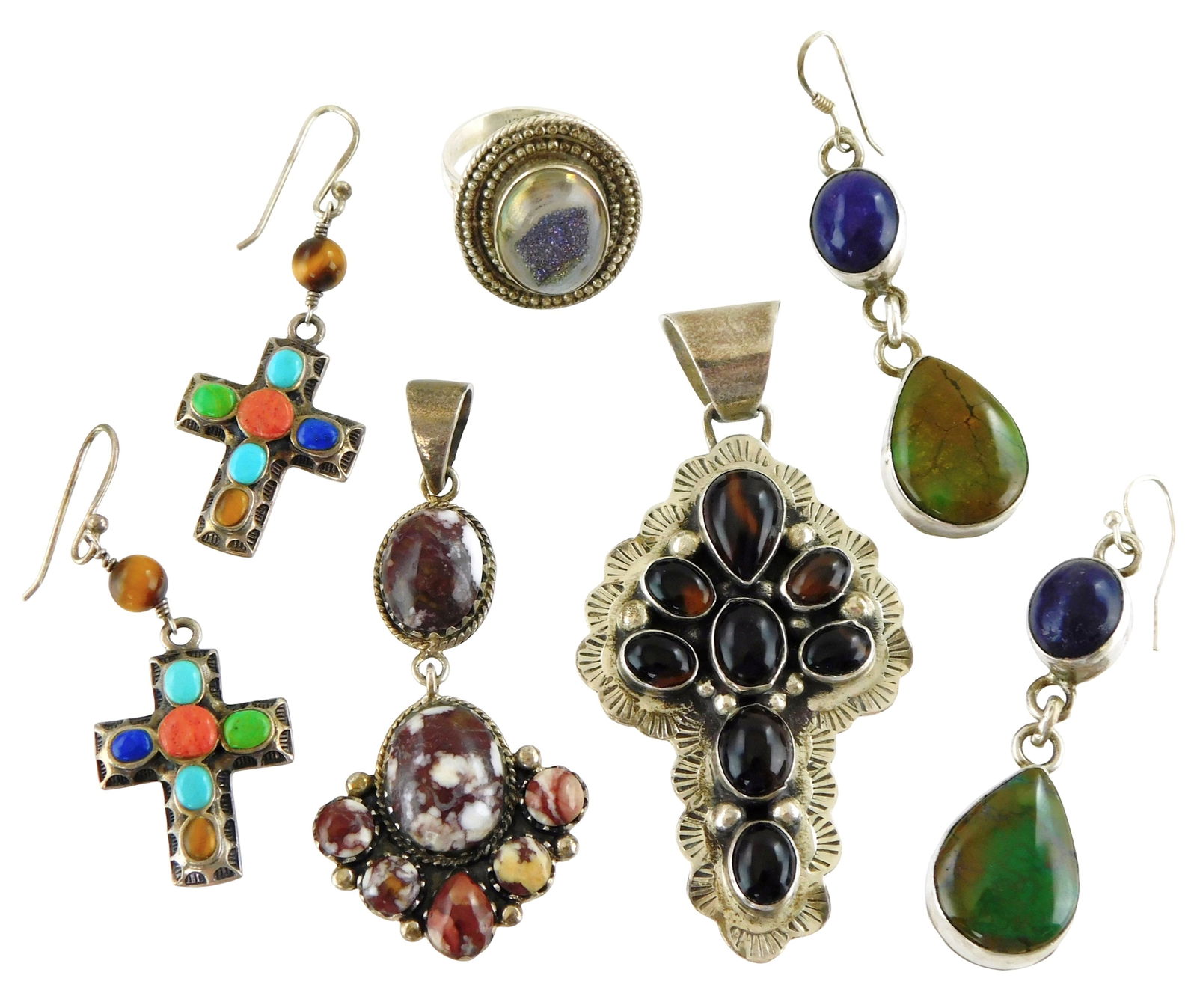 JEWELRY: Set of five sterling silver pieces of jewelry , including a Peter Johnson (Native American,: JEWELRY: Set of five sterling silver pieces of jewelry , including a Peter Johnson (Native American, 1956) Navajo tiger’s eye sterling cross pendent, marked “PJ Sterling”; a southwestern sty