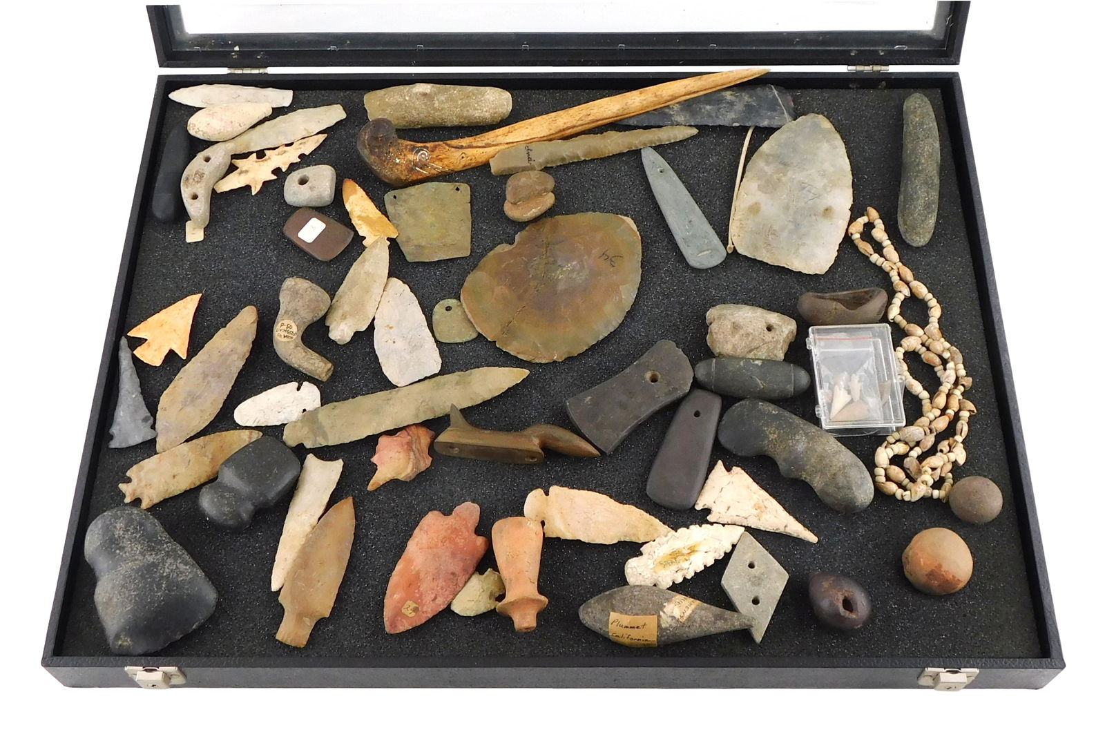 50+ Indigenous-type artifacts, most American, details include: carved birdstone, many projectile: 50+ Indigenous-type artifacts, most American, details include: carved birdstone, many projectile points of various sizes and shapes, mauls and ax heads, pendants including two copper, bone awls, balls