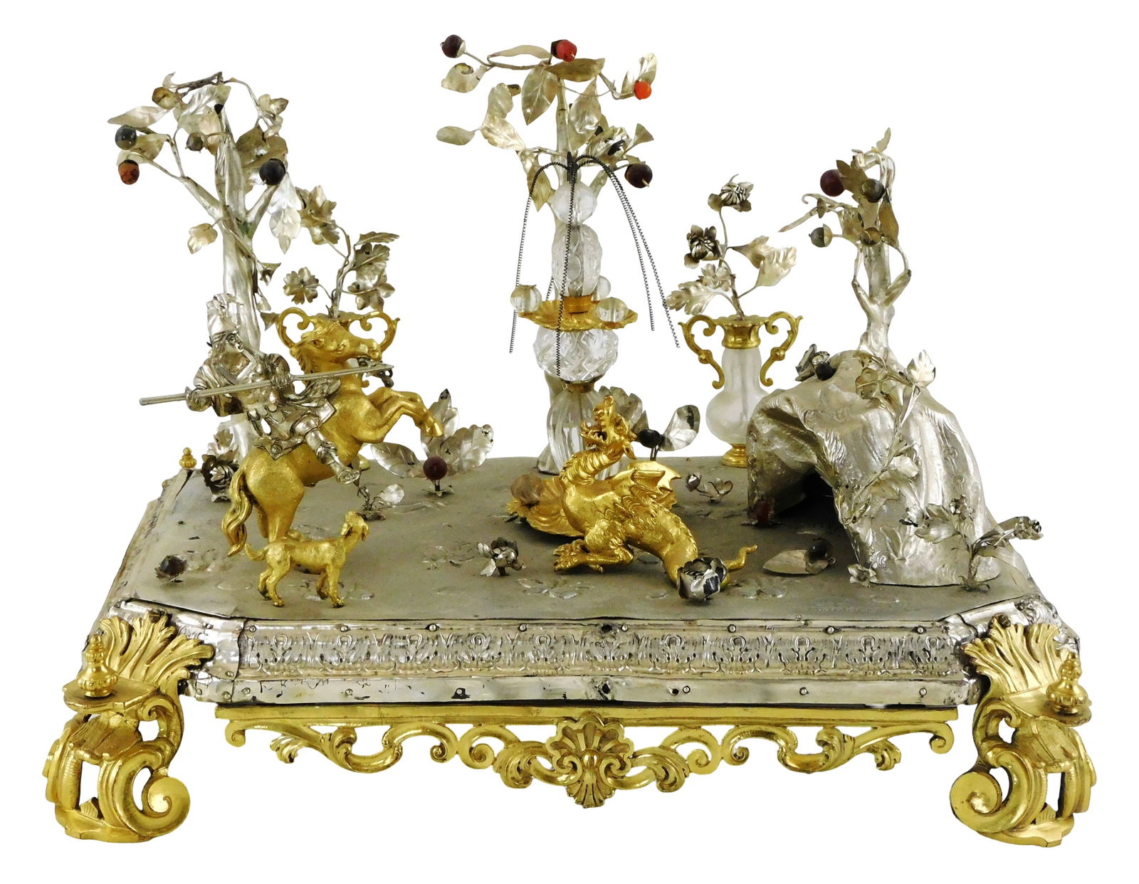 Figural centerpiece, likely Italian with 17th C. and later elements, assorted metals on wood: Figural centerpiece, likely Italian with 17th C. and later elements, assorted metals on wood support, features St. George on horseback with a spear aimed at a winged dragon with nearby cave, fruit bea