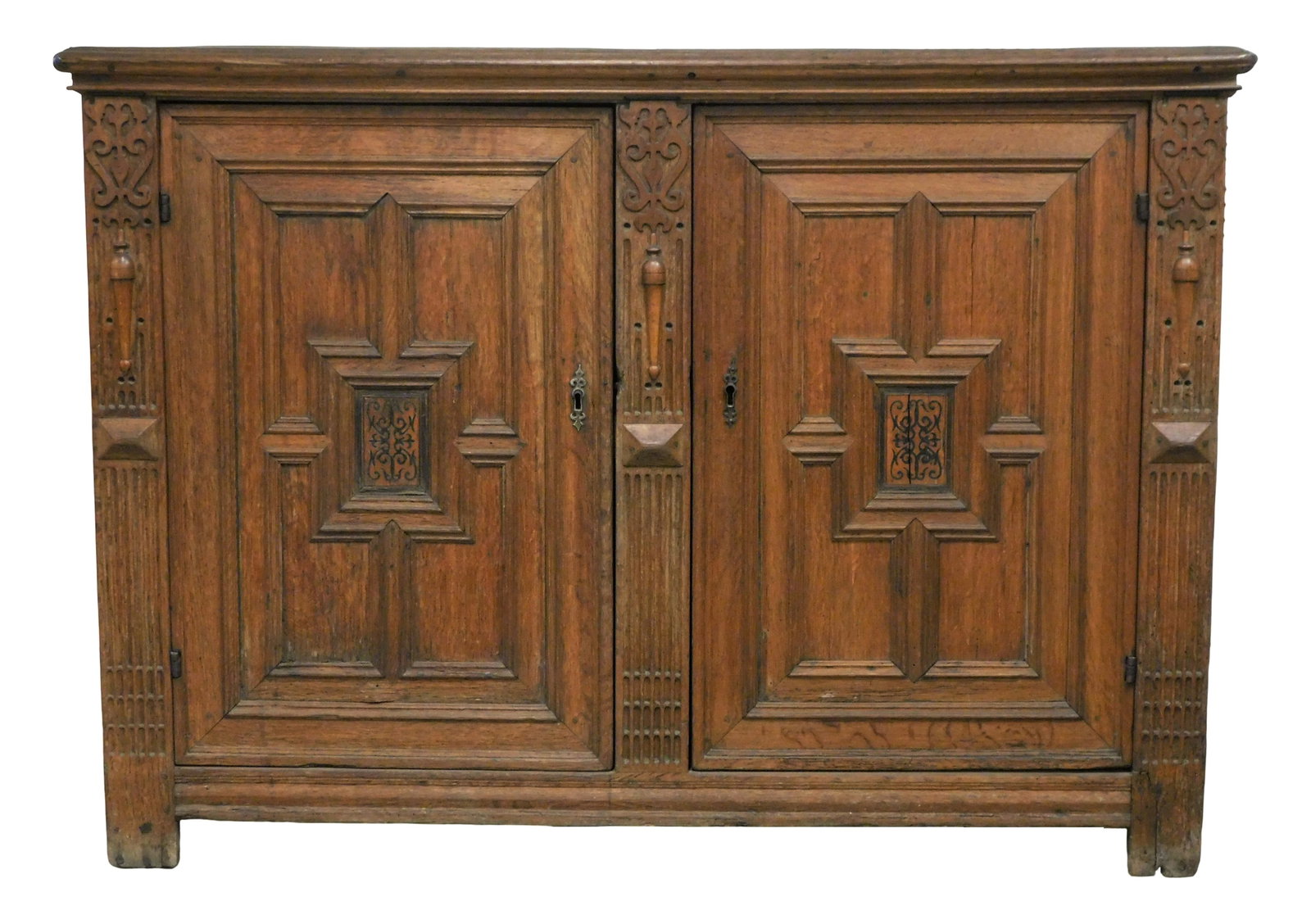 Oak paneled cupboard, Dutch, late 17th – 18th C., top with under edge molding over two: Oak paneled cupboard, Dutch, late 17th – 18th C., top with under edge molding over two multi-paneled doors, center panel carved and colored, fluted and carved front pilasters, paneled sides, refinis
