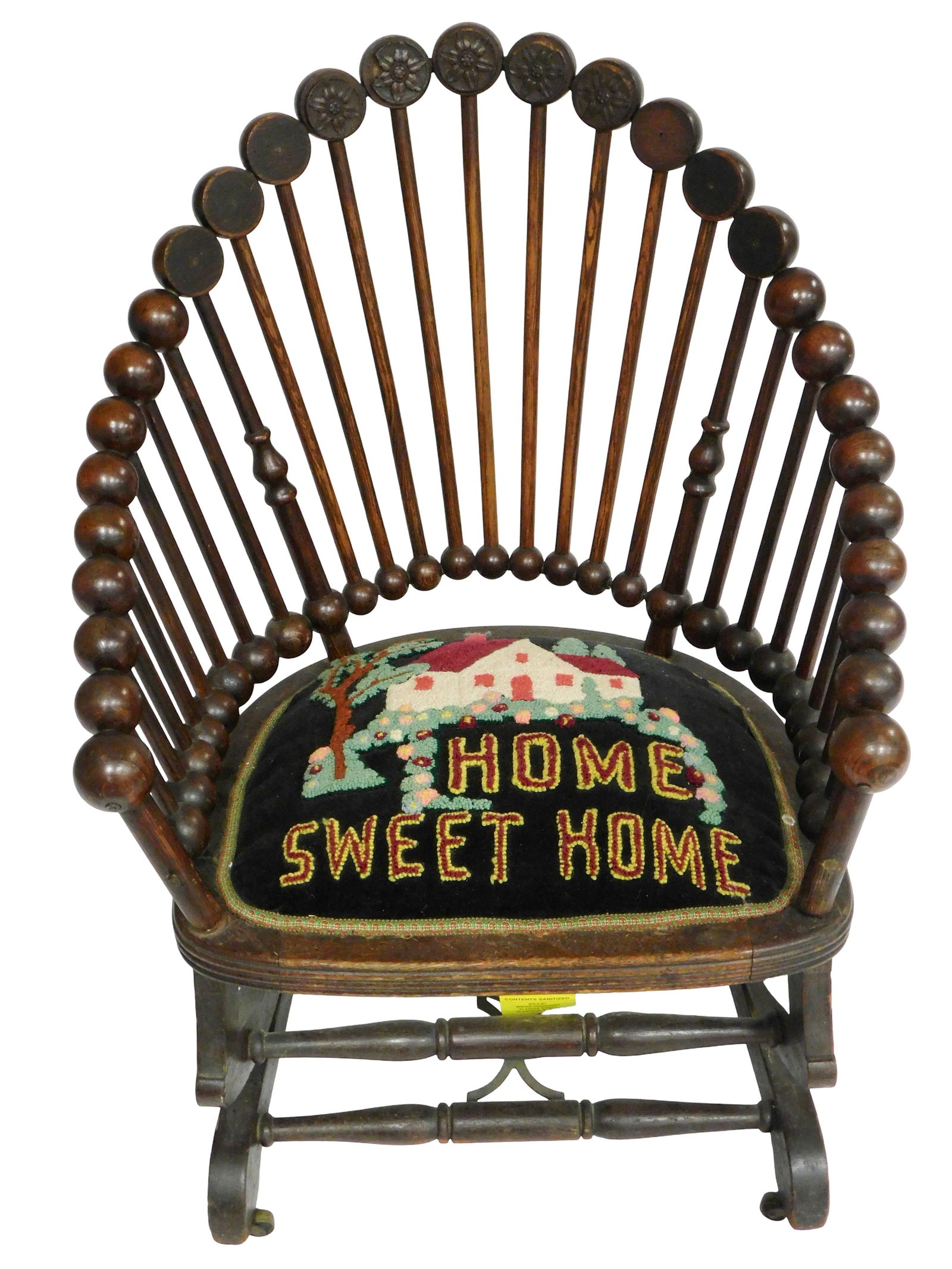 Platform rocker, American, 20th C., walnut, with spindle form “lollipop?? back, “Home Sweet: Platform rocker, American, 20th C., walnut, with spindle form “lollipop” back, “Home Sweet Home” embroidery, hooked seat, wear expected with age and use including some chipping, 33" x