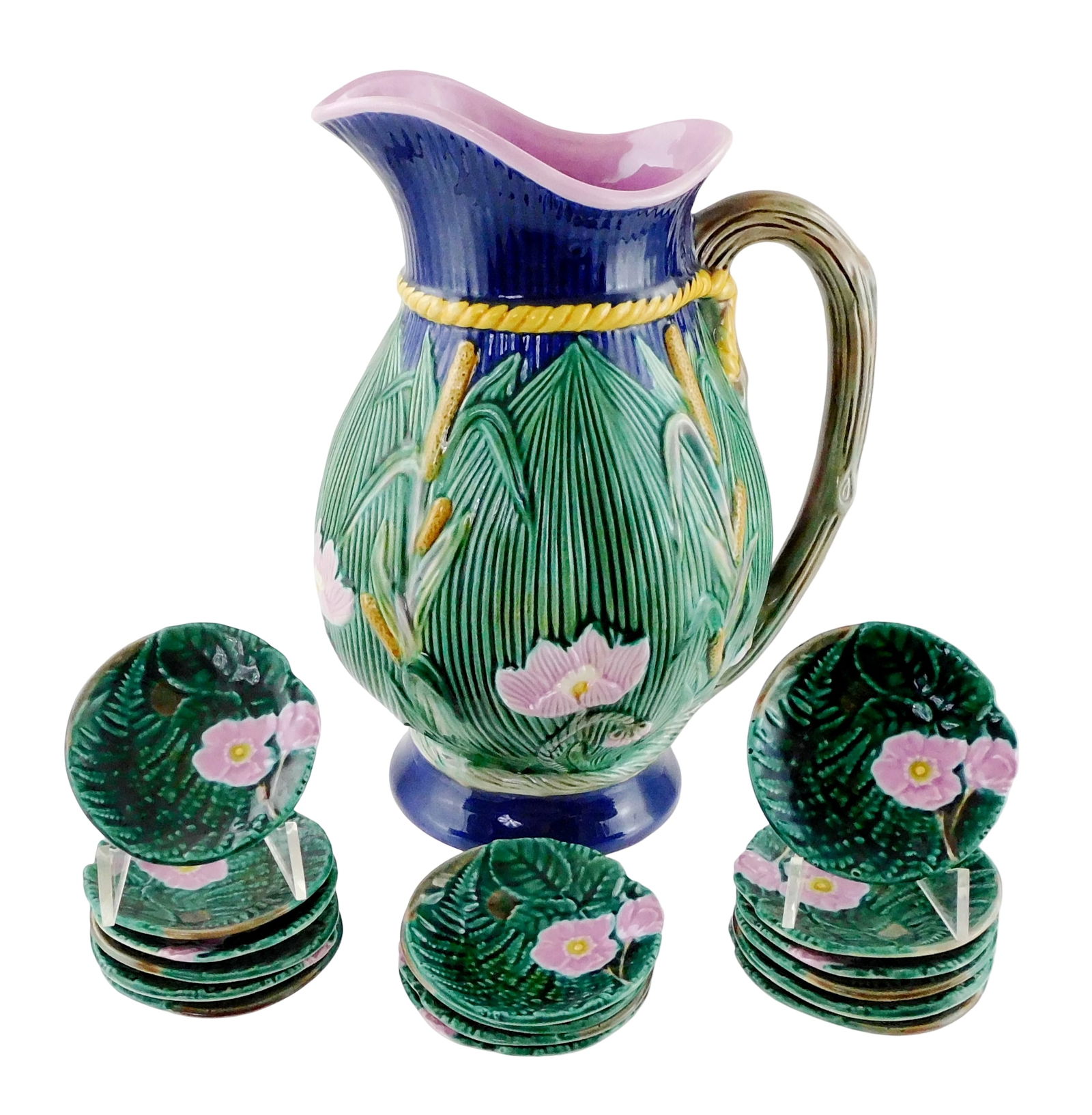 MAJOLICA: George Jones "Bulrush and Lily" water pitcher and sixteen butter pats, England, late 19th: MAJOLICA: George Jones "Bulrush and Lily" water pitcher and sixteen butter pats, England, late 19th C., porcelain, polychrome glaze on blue ground, raised decoration throughout, marked on base, wear c
