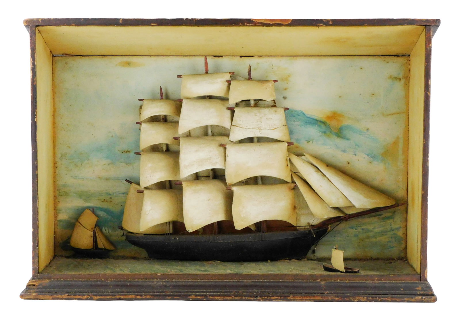 Maritime diorama in brown shadowbox, late 19th- 20th C., painted and carved wood depicting three (1 of 3)