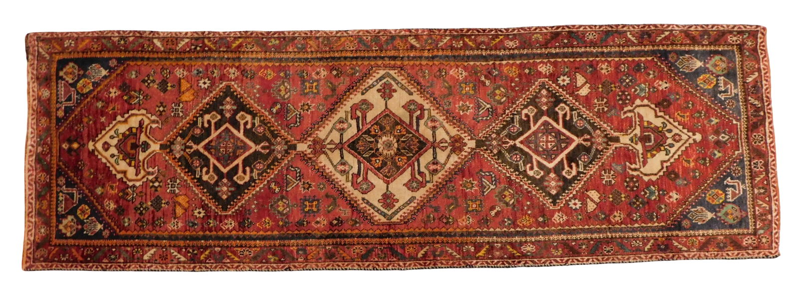 RUG: Quashqai, 2' 6" x 6', wool on wool, 1940's, light red ground with central diamond medallions, (1 of 4)