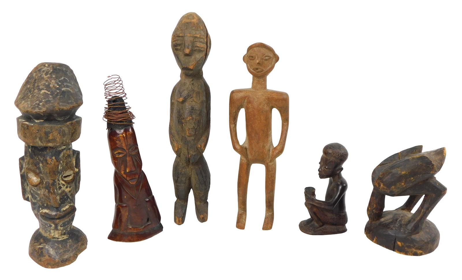 TRIBAL: Six West African carved figures, 20th C., all carved wood, including: sitting figure holding (1 of 2)