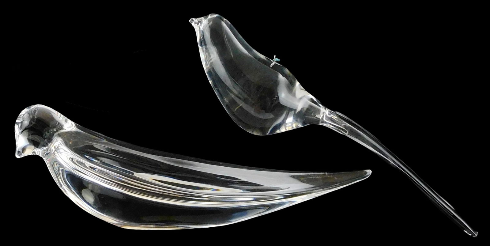 ART GLASS: Two Steuben crystal birds, both with signed base, including: love bird, elongated body,: ART GLASS: Two Steuben crystal birds, both with signed base, including: love bird, elongated body, additional “Joel A. Smith” signature etched under wing, 2 3/8” h. x 7 1/4” l.; an