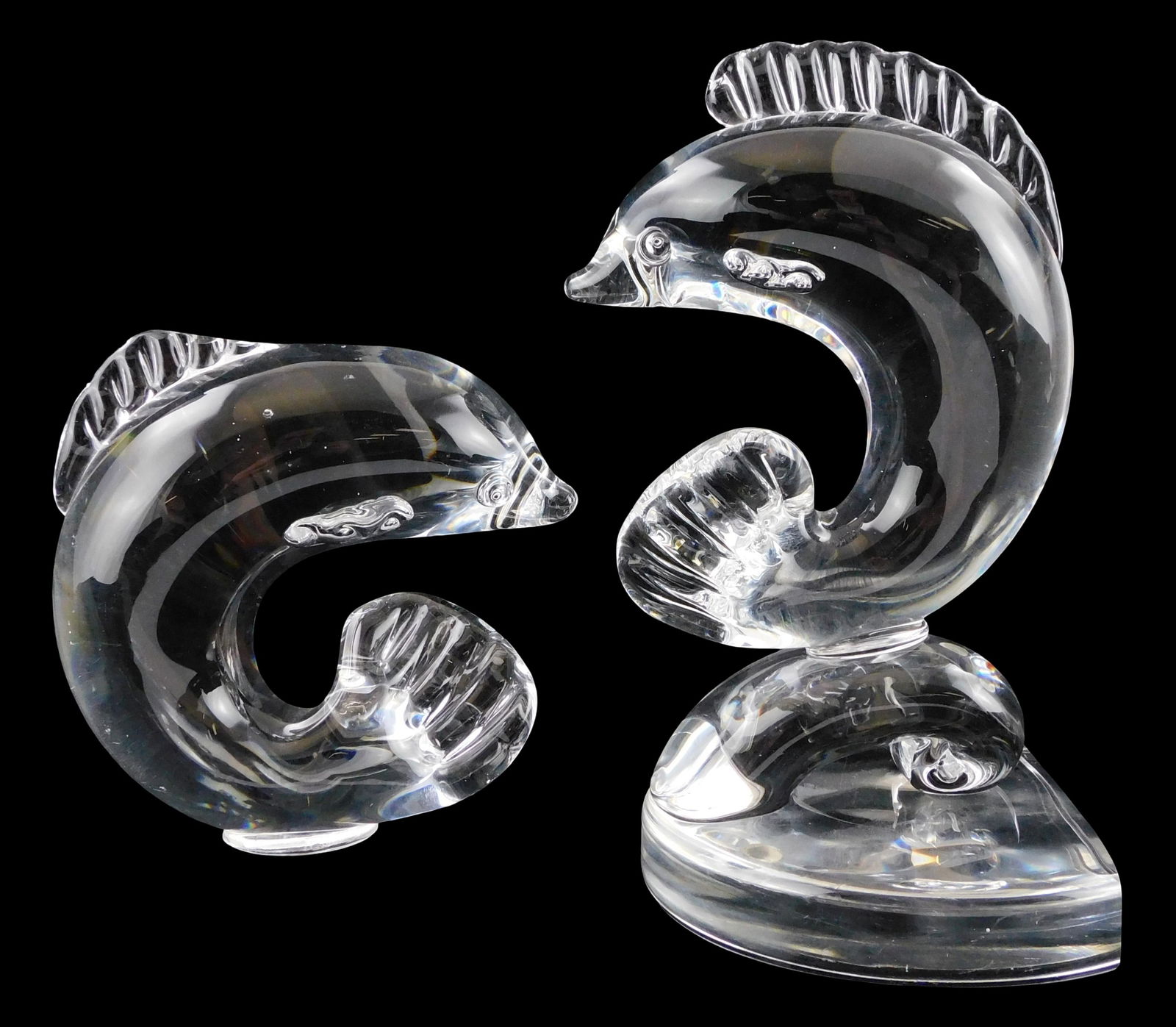 ART GLASS: Two Steuben dolphins, mid-20th C., both in stylized form with ribbed applied dorsal fin, (1 of 3)