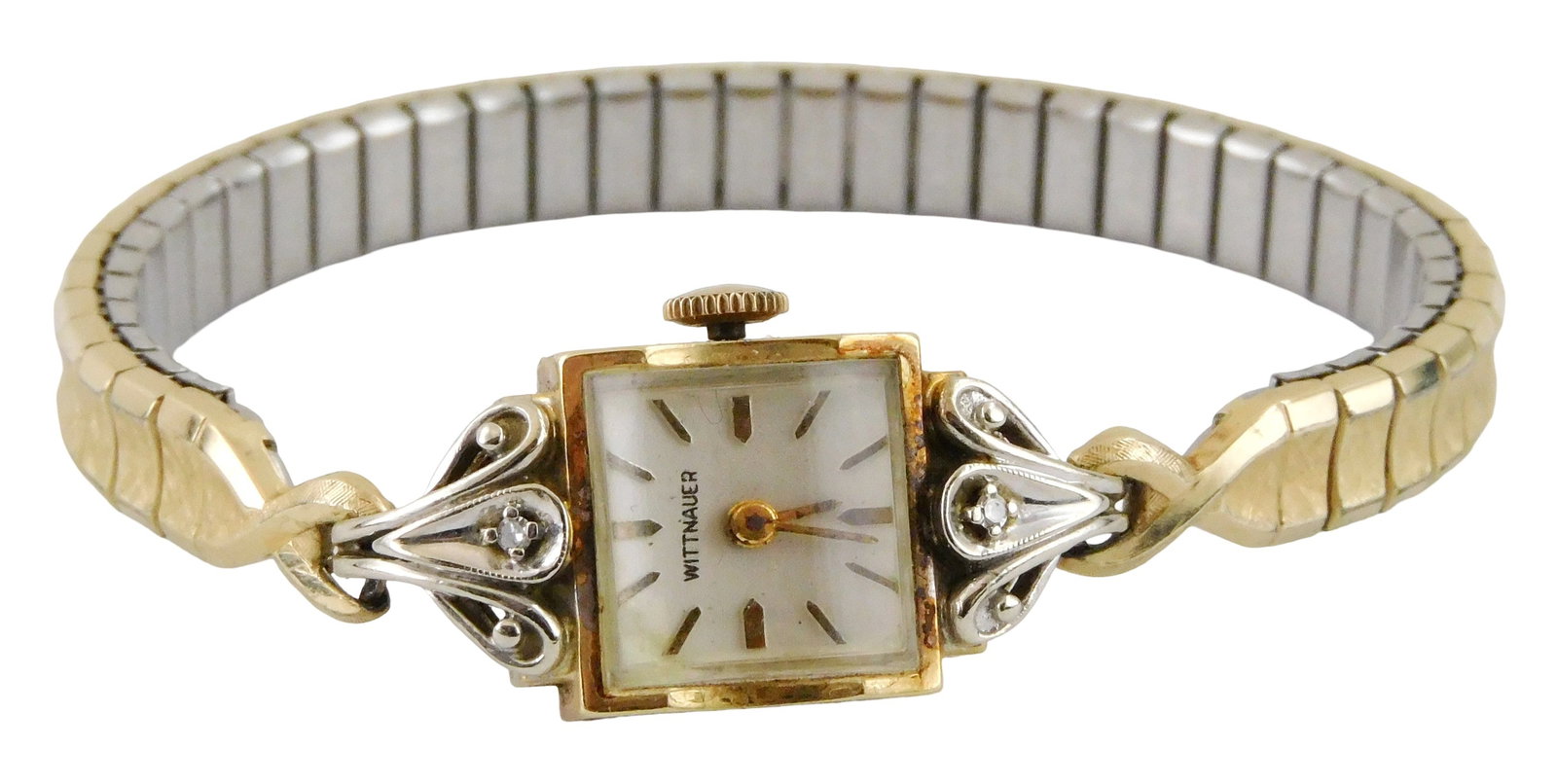 JEWELRY: 14K Wittnauer gold women's wristwatch, stamped "14K", square case, set with two white: JEWELRY: 14K Wittnauer gold women's wristwatch, stamped "14K", square case, set with two white stones flanking face, base metal expansion band attached to watch, unknown working condition, wear consis
