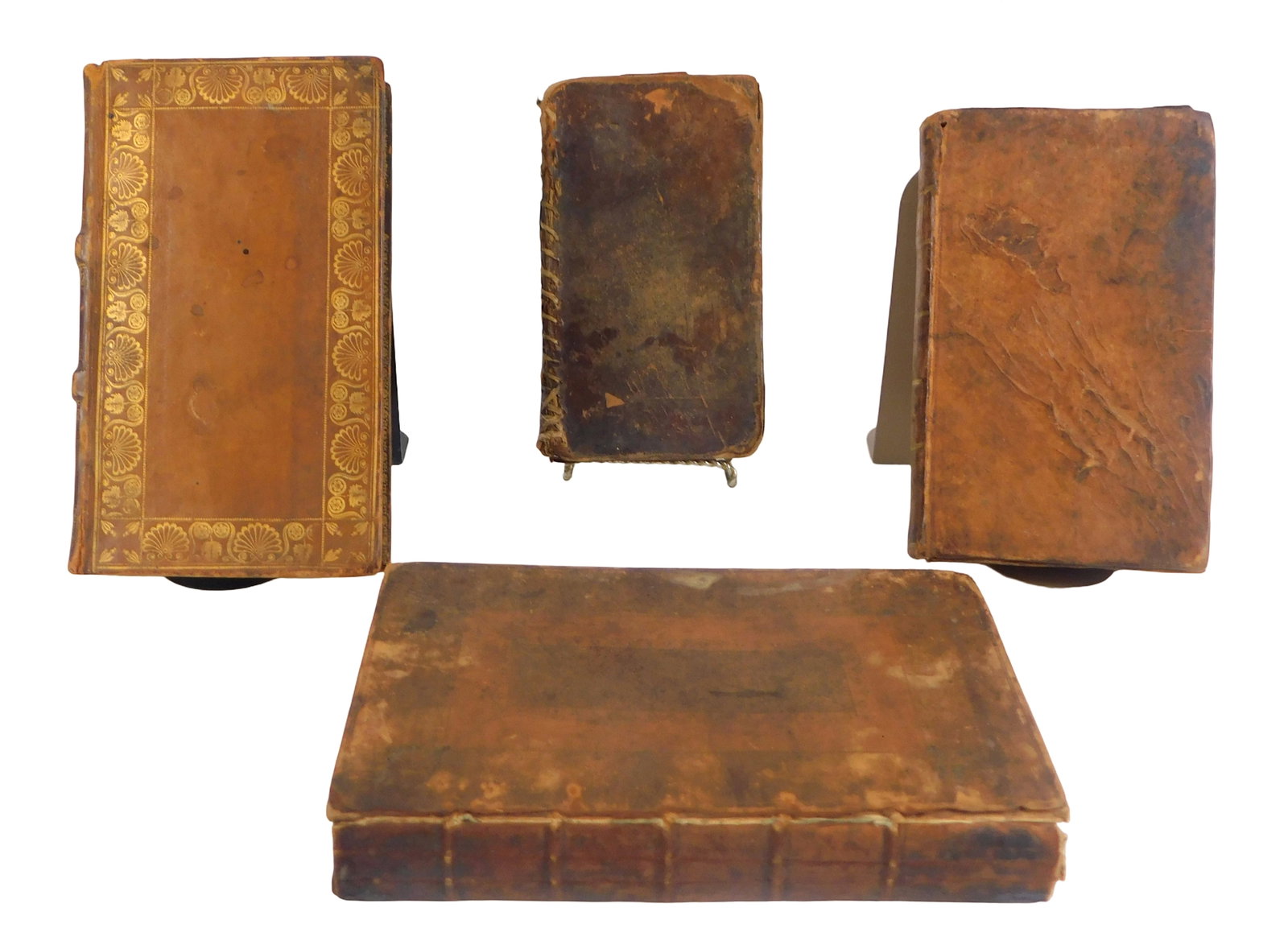 Group of four early volumes c. 1691–1824 illustrating book use, binding, and repair, including: (1 of 8)