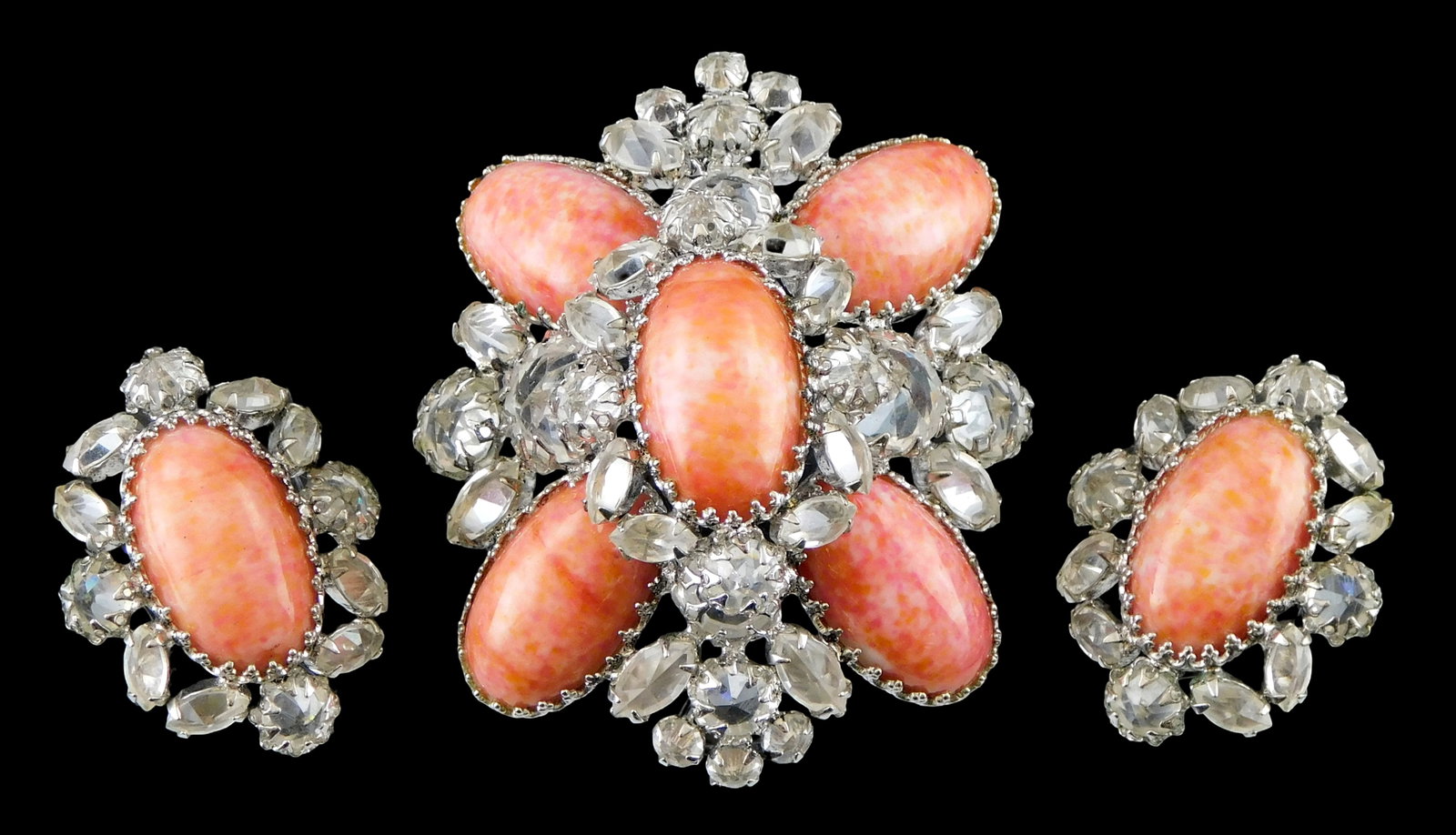 COSTUME JEWELRY: Brooch and earrings set by Schreiner, New York, 20th C., signed on brooch, all with: COSTUME JEWELRY: Brooch and earrings set by Schreiner, New York, 20th C., signed on brooch, all with coral colored cabochon stones ensconced with clear crystals and set in a white metal frame, non-pie