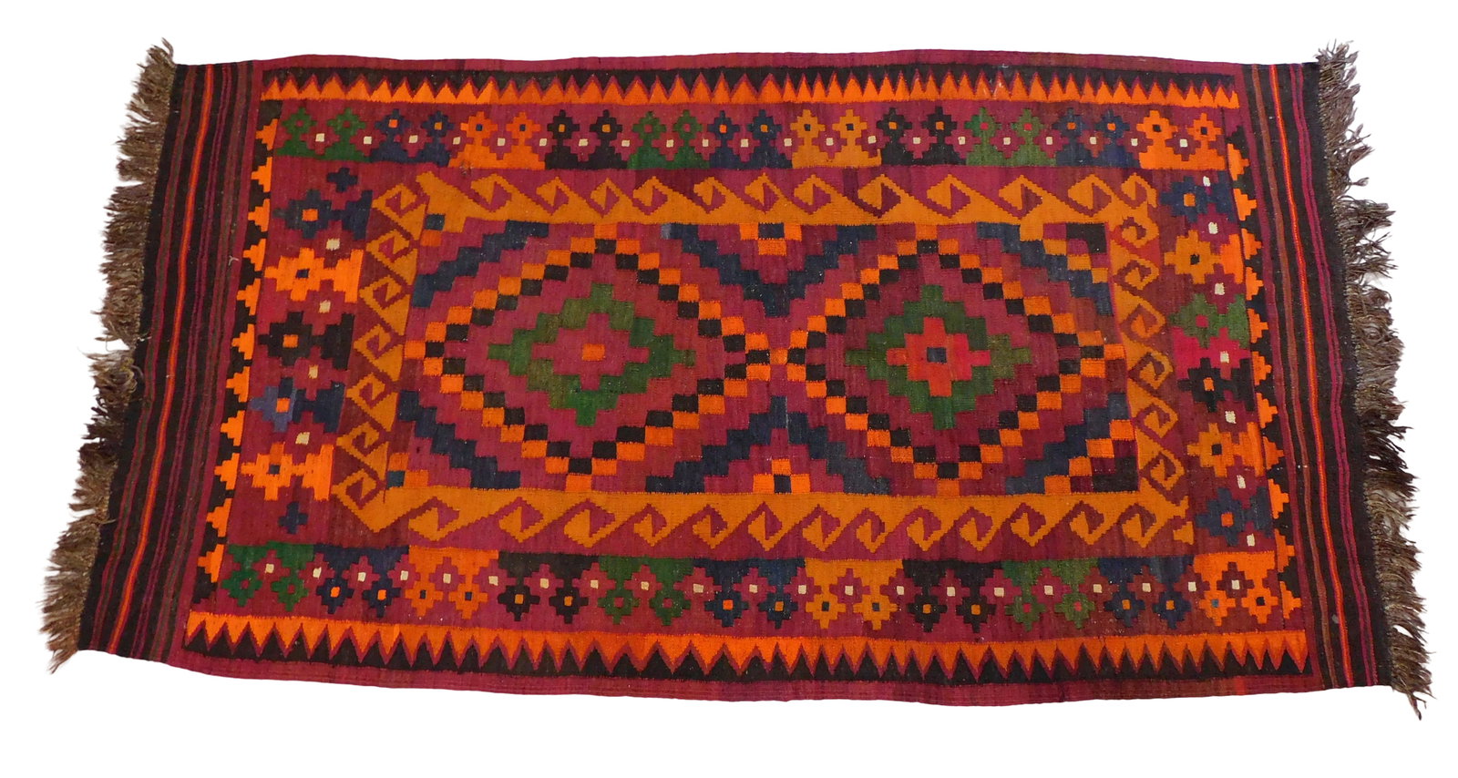 RUG: Turkish Kilim runner, 7' 8" x 4' 2", wool on wool, burnt orange and burgundy geometrical: RUG: Turkish Kilim runner, 7' 8" x 4' 2", wool on wool, burnt orange and burgundy geometrical patterns on dark brown ground, green, mustard, crimson and navy-blue accents, wear consistent with age and