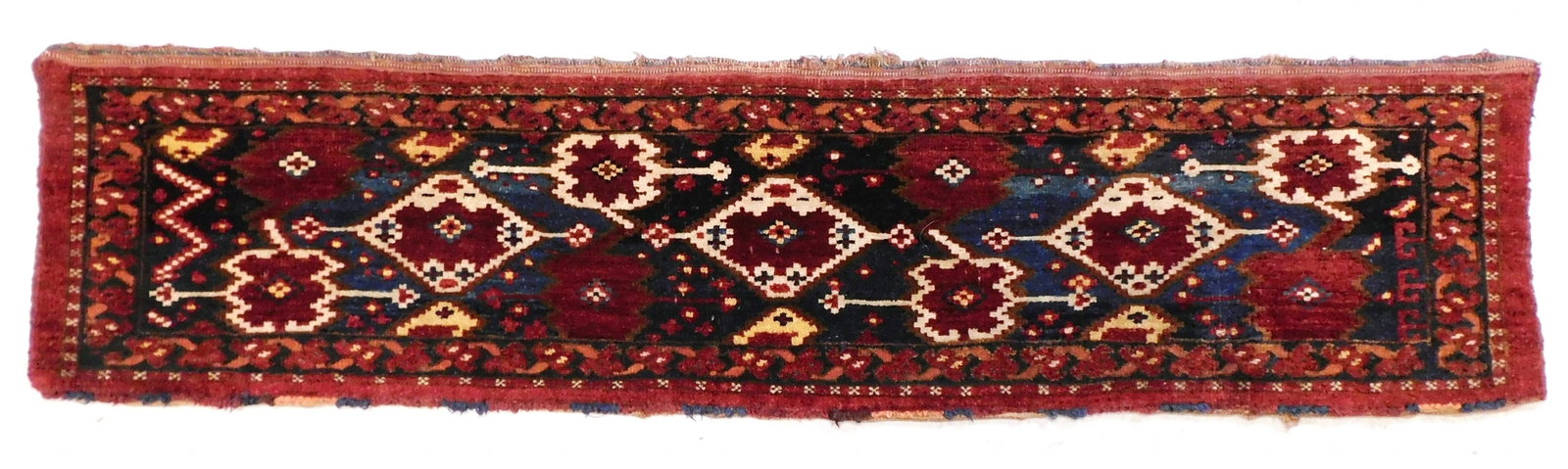 RUG: Antique Bokhara diminutive runner/ bagface, 5' 2" x 1' 3", wool on wool, analogous blue ground, (1 of 3)