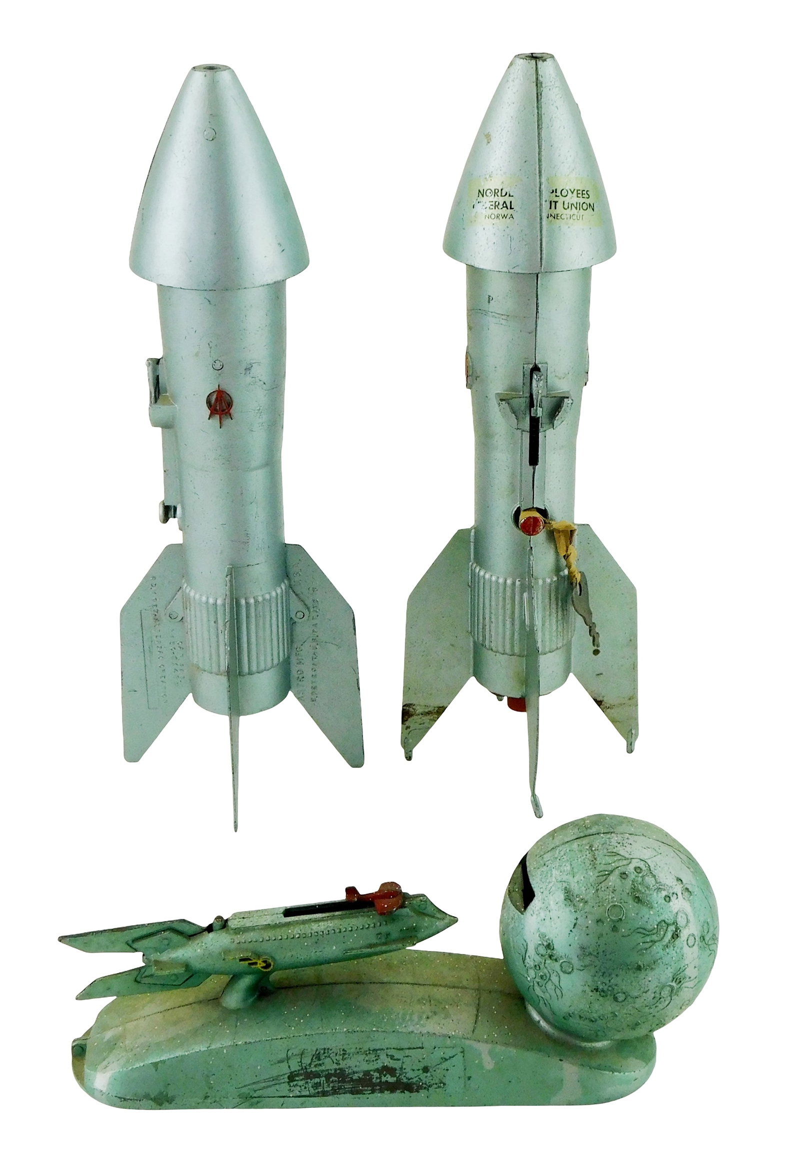Three space-themed mechanical metal banks, 1950s-1960s, including: Duro Strato rocket "Shoot the (1 of 3)