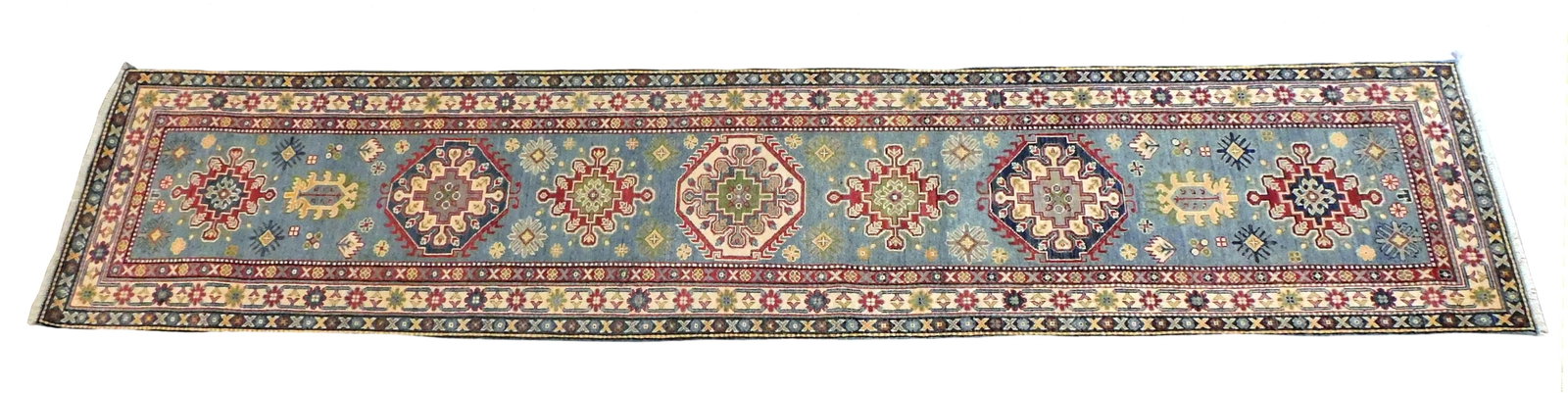 RUG: Uzbek Kazak runner, 2' 8" x 12' 6", wool on cotton, classic geometric motifs, wear consistent: RUG: Uzbek Kazak runner, 2' 8" x 12' 6", wool on cotton, classic geometric motifs, wear consistent with age and use.