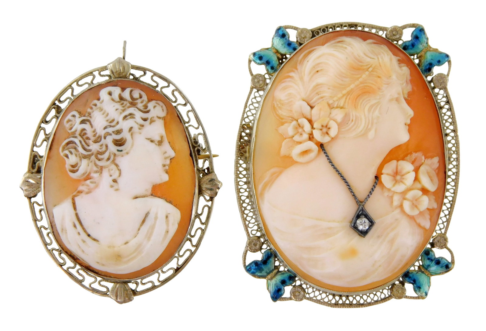 JEWELRY: Two cameo pendant brooches set in 14K white gold frames, both stamped 14K, larger nicely: JEWELRY: Two cameo pendant brooches set in 14K white gold frames, both stamped 14K, larger nicely carved female figure with flowers in hair and filigree frame featuring enameled butterfly decoration a