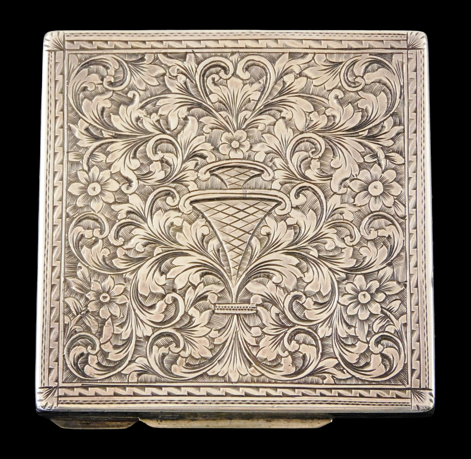 SILVER: '800' Silver ladies compact with finely etched foliate scroll decoration to both covers and: SILVER: '800' Silver ladies compact with finely etched foliate scroll decoration to both covers and interior panel, stamped '800', interior with mirror and rouge compartment, wear consistent with age 