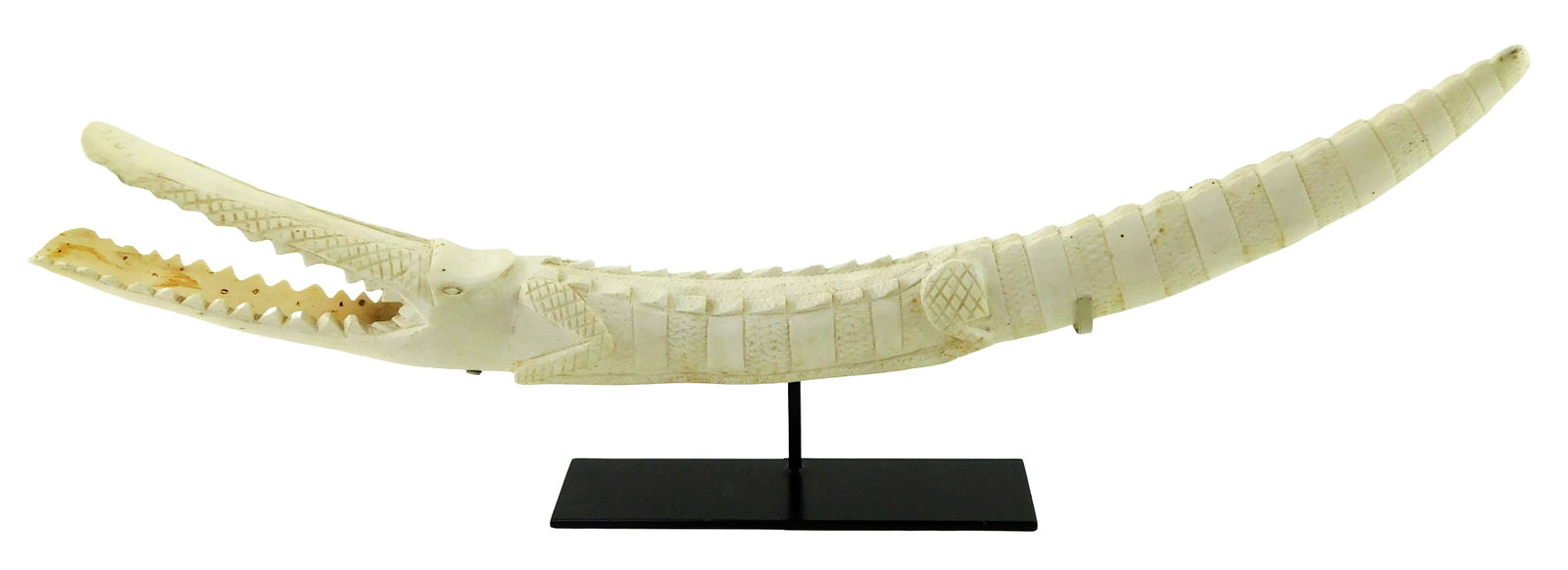TRIBAL: African carved tusk in the form of a crocodile, 20th C., crosshatch and etched decoration: TRIBAL: African carved tusk in the form of a crocodile, 20th C., crosshatch and etched decoration throughout, no signature viewed, matte finish, rests on custom, fitted stand, wear consistent with age