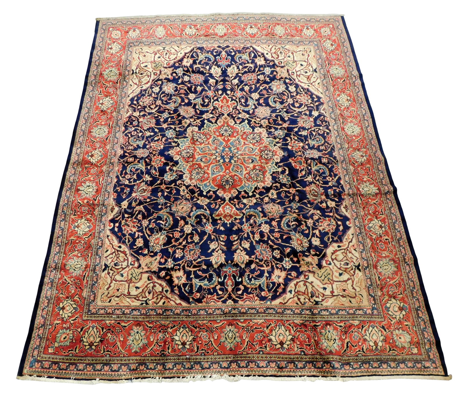 RUG: Mashad carpet, 12' 4" x 9' 8", Iran, wool on cotton, hand-knotted, foliate motif with: RUG: Mashad carpet, 12' 4" x 9' 8", Iran, wool on cotton, hand-knotted, foliate motif with spandrels, navy ground, tomato red primary border, accents of cream, tan, celadon, salmon, steel blue, maize,