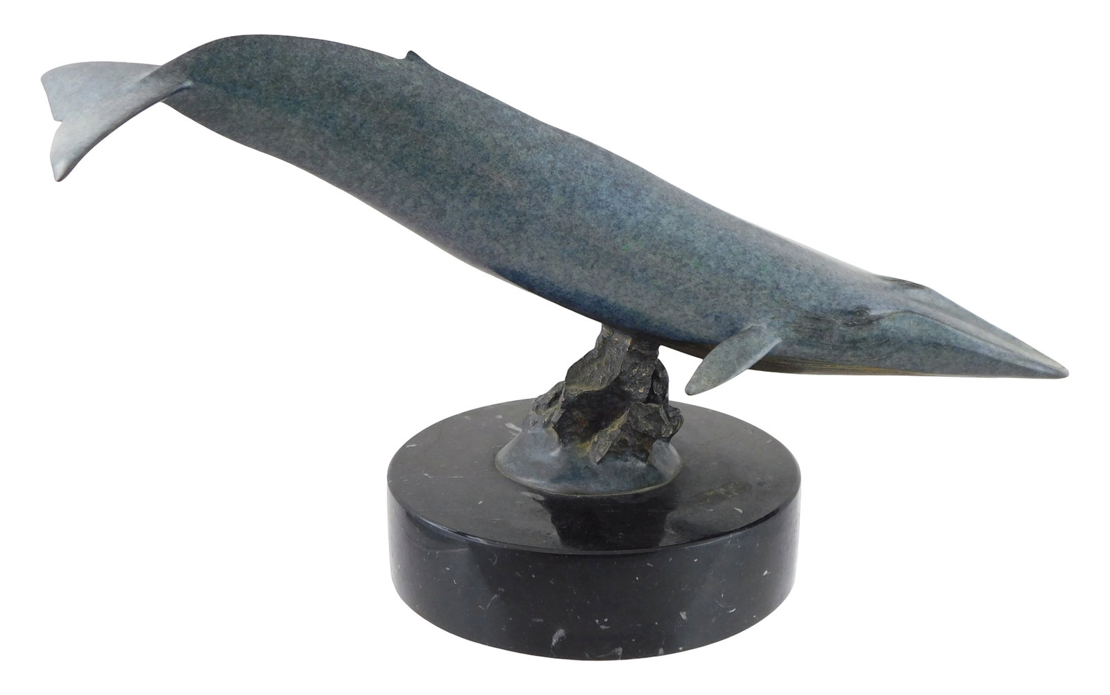 Randy Puckett (American, b. 1946), edition 133/250, c. 1984, bronze sculpture of blue whale mounted: Randy Puckett (American, b. 1946), edition 133/250, c. 1984, bronze sculpture of blue whale mounted on small pile of rocks, all on black marble base, signed and numbered on rock base, wear consistent 