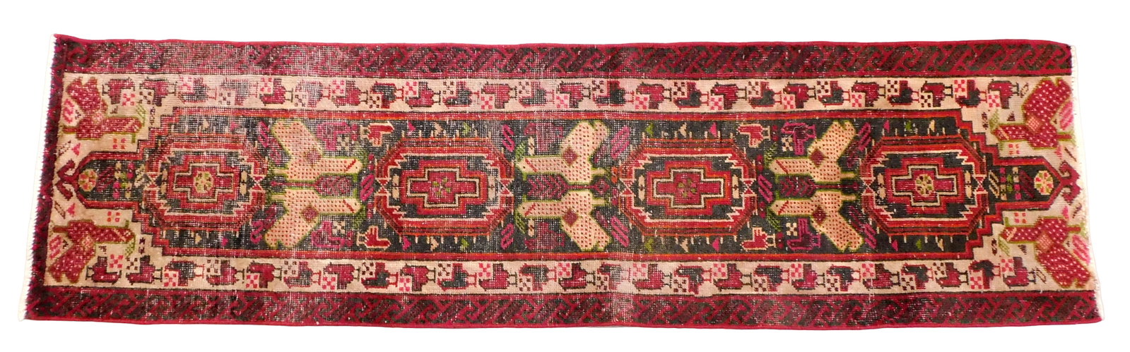 RUG: Heriz runner; 2' 1" x 7' 5", wool on cotton, black ground, beige border, red and black minor: RUG: Heriz runner; 2' 1" x 7' 5", wool on cotton, black ground, beige border, red and black minor borders, repeating geometrical patterns, bird motifs throughout, repeating medallions, wear consistent