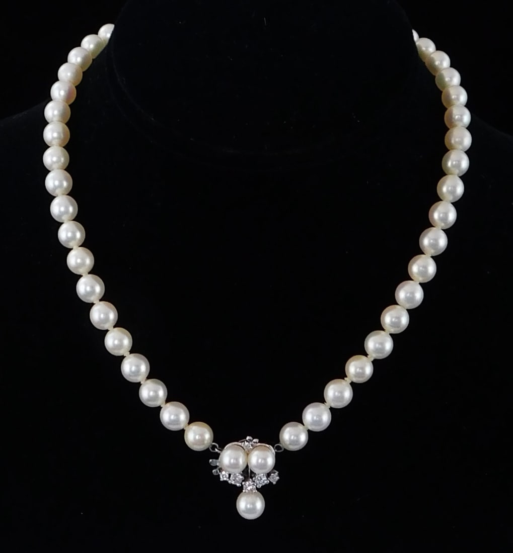 JEWELRY: Cultured pearl necklace with 14K gold and diamond clasp, necklace with fifty round cultured: JEWELRY: Cultured pearl necklace with 14K gold and diamond clasp, necklace with fifty round cultured pearls [pearls 7.0-7.5mm each], white, medium to high luster, fancy box safety clasp stamped and te
