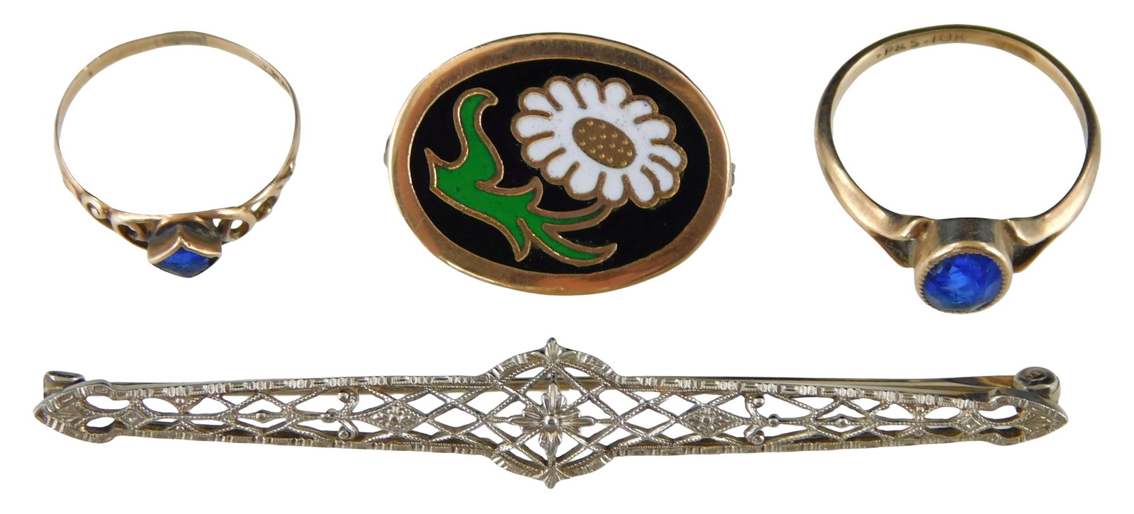 JEWELRY: Four stamped 10K gold pieces, including: one enameled pin with daisy decoration; one white: JEWELRY: Four stamped 10K gold pieces, including: one enameled pin with daisy decoration; one white fold filigree bar pin; and two baby/ child's rings, each mounted with blue center stone, one chipped