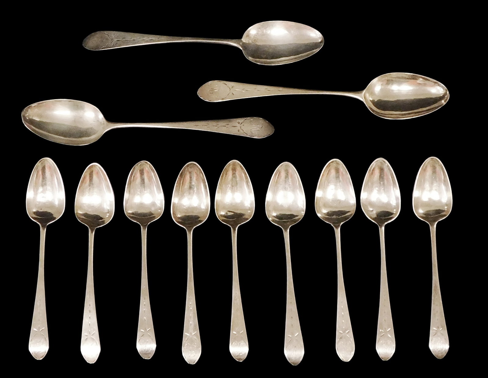 COIN SILVER: Twelve early spoons with bright cut engraving, three tablespoons and nine teaspoons,: COIN SILVER: Twelve early spoons with bright cut engraving, three tablespoons and nine teaspoons, all stamped on reverse with varied makers, different monograms to handle, tested silver, wear consiste