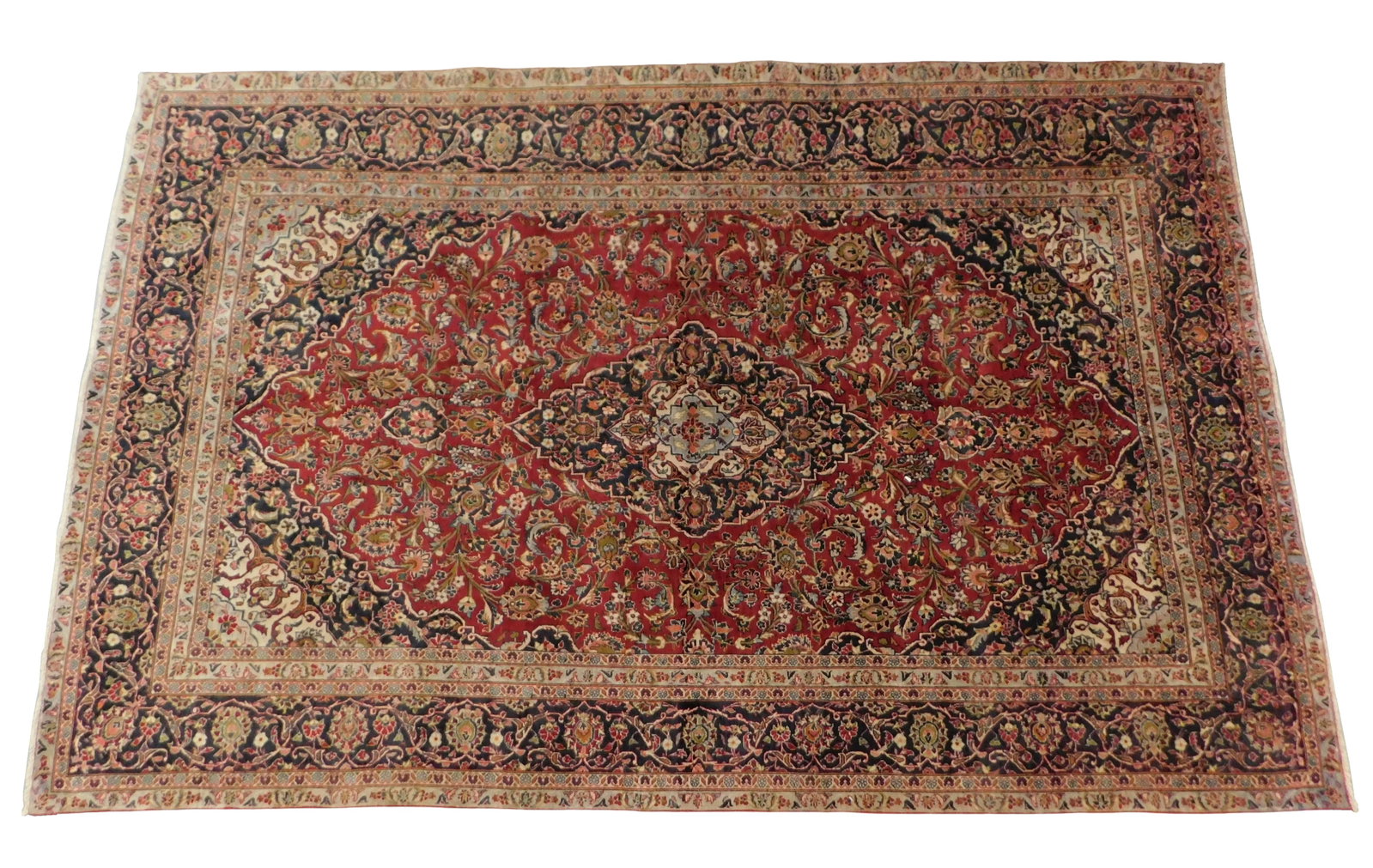 RUG: Kashan, 7' 8" x 11' 11", wool on cotton, red ground, navy major borders, beige and grey minor: RUG: Kashan, 7' 8" x 11' 11", wool on cotton, red ground, navy major borders, beige and grey minor borders, central medallion, floral and leaf motifs throughout, wear consistent with age and use inclu