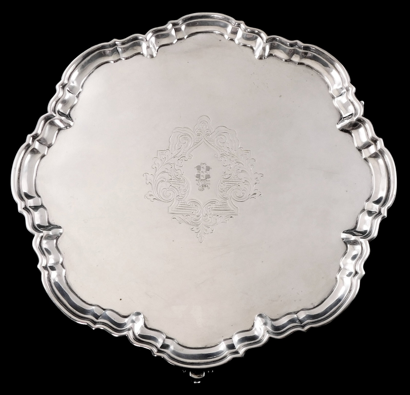 STERLING: Large English sterling silver salver, London, 1905, raised on three scroll feet, stepped: STERLING: Large English sterling silver salver, London, 1905, raised on three scroll feet, stepped and shaped rim, engraved shield in cartouche at center, hallmarks on reverse include lion standard, p