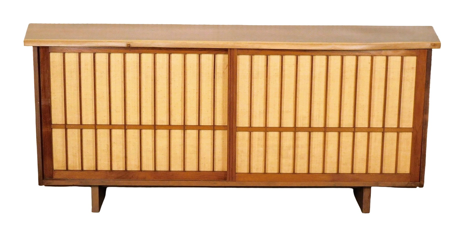 George Nakashima (American, 1905-1990), "Double Sliding Door Cabinet", 1955, American black walnut: George Nakashima (American, 1905-1990), "Double Sliding Door Cabinet", 1955, American black walnut with pandanus cloth, overhang top with free edge atop two sliding doors concealing media compartments