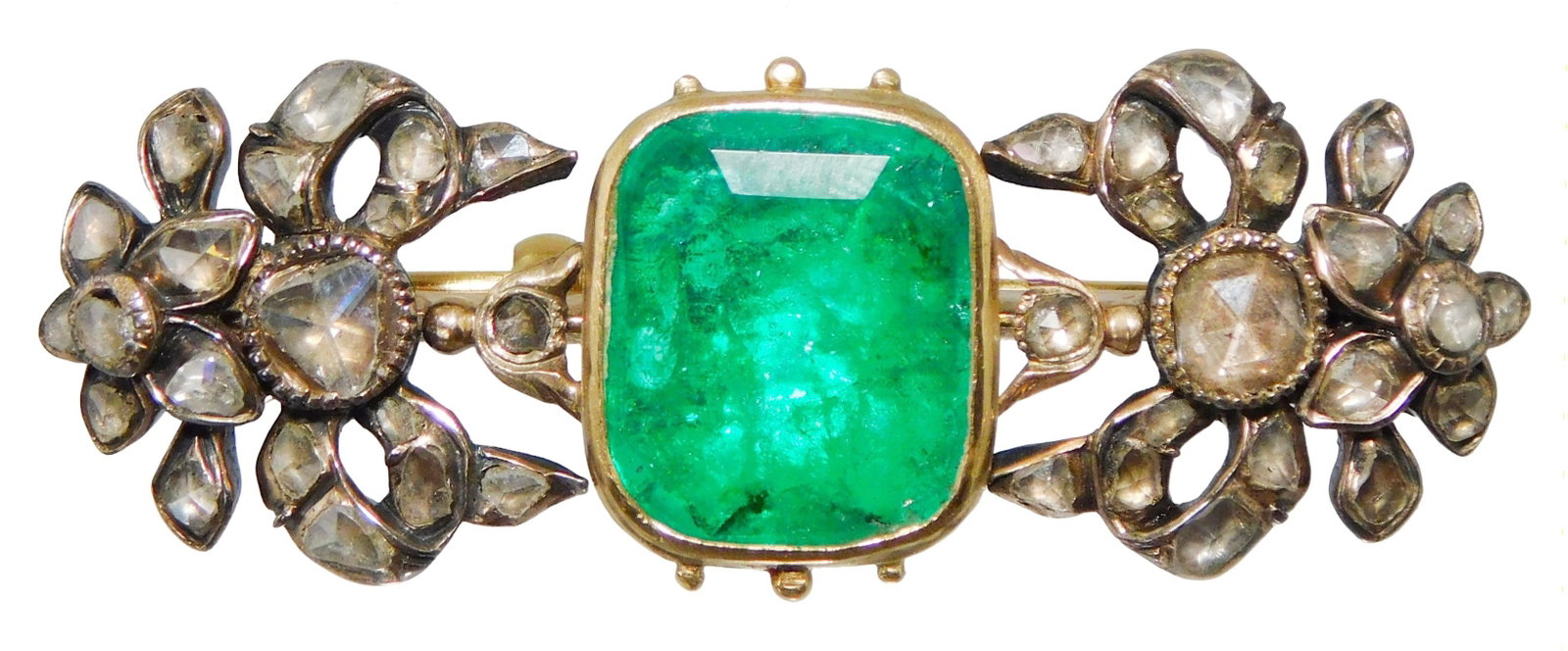 JEWELRY: 14K and silver emerald and diamond brooch, setting tested 14K yellow gold, center bezel: JEWELRY: 14K and silver emerald and diamond brooch, setting tested 14K yellow gold, center bezel setting and pin stem with silver diamond settings, gold plated clutch on pen stem, 2" long; center set 