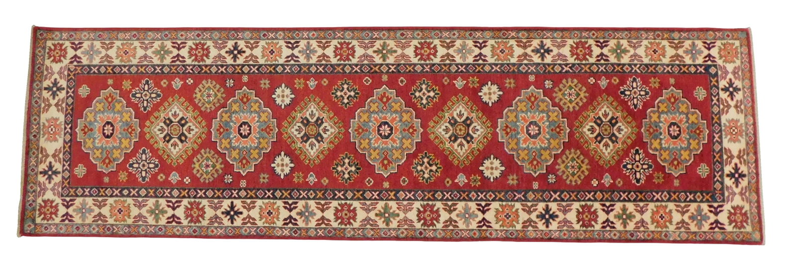 RUG: Uzbek Kazak runner, 2' 9" x 9' 5", wool on cotton, red ground, cream border, wear consistent: RUG: Uzbek Kazak runner, 2' 9" x 9' 5", wool on cotton, red ground, cream border, wear consistent with age and use, made in the last ten years.