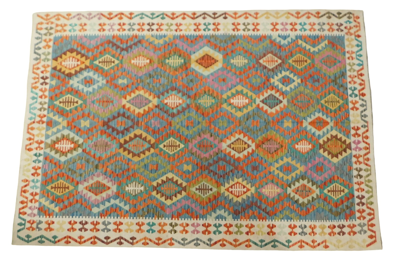 RUG: Turkish Kilim, 6' 9" x 9' 8", wool on wool, blue ground, cream border, polychrome geometric: RUG: Turkish Kilim, 6' 9" x 9' 8", wool on wool, blue ground, cream border, polychrome geometric design, wear consistent with age and use, made in the last ten years.