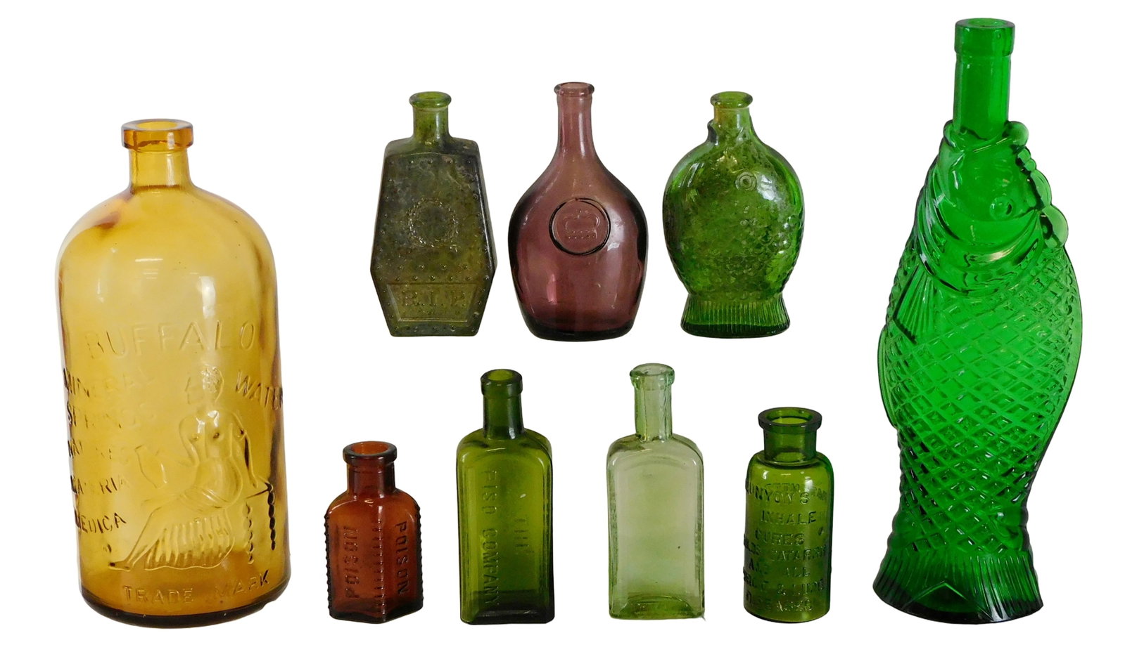 GLASS: Colored glass embossed advertising bottles, nine pieces, late 19th- 20th C., details include: (1 of 8)