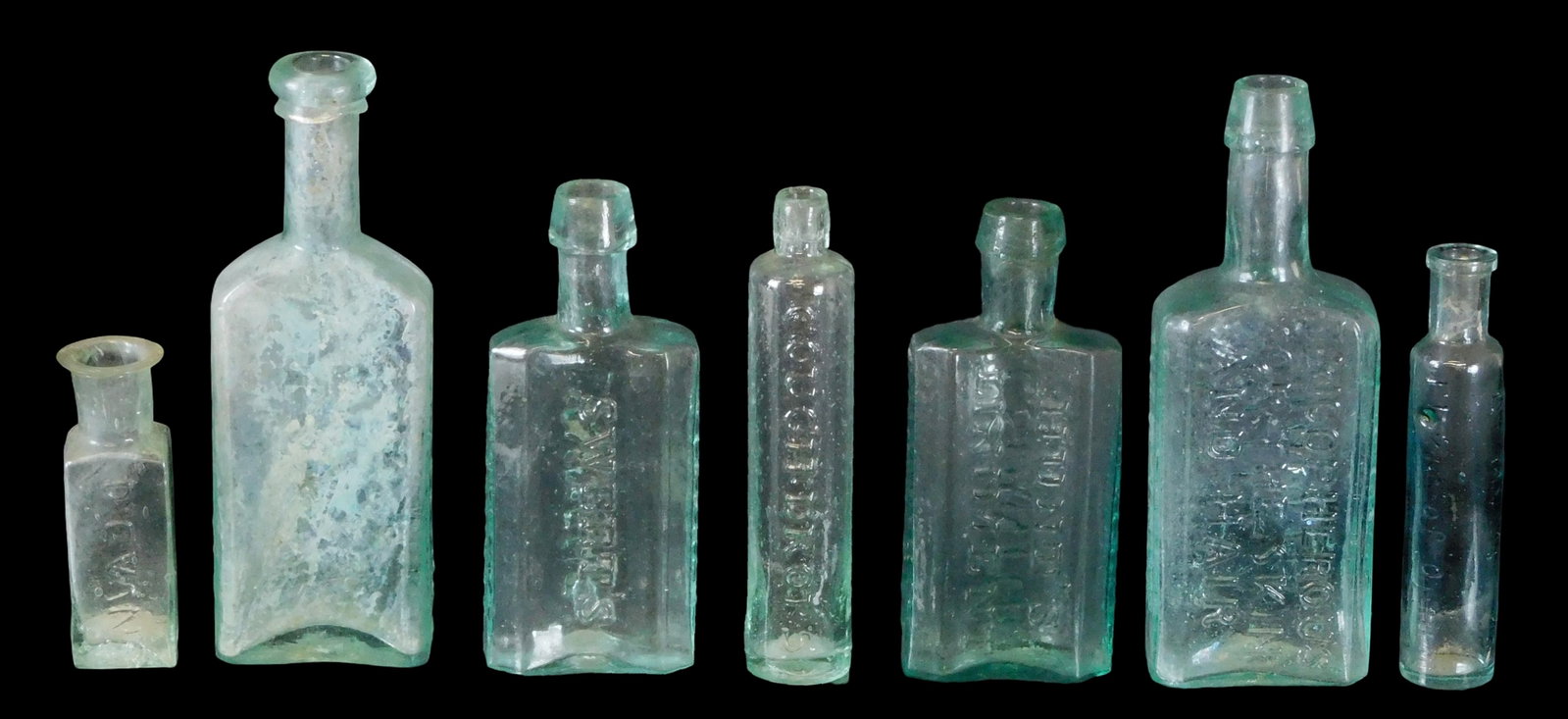 GLASS: Seven early embossed medicine bottles, mid to late 19th C., United States, most with pontil (1 of 6)
