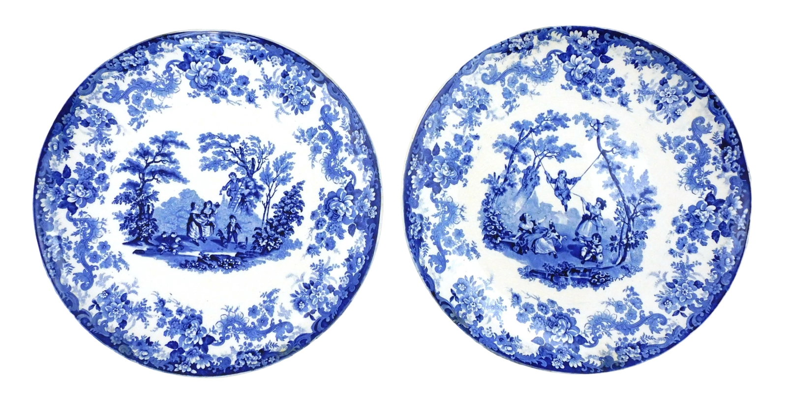 Pair of Minton and Hollins blue and white transferware chargers, c. 1852, England, both with: Pair of Minton and Hollins blue and white transferware chargers, c. 1852, England, both with 'Watteau' scenes, first with boy climbing ladder up tree, girls watch below, another boy plays with chicken