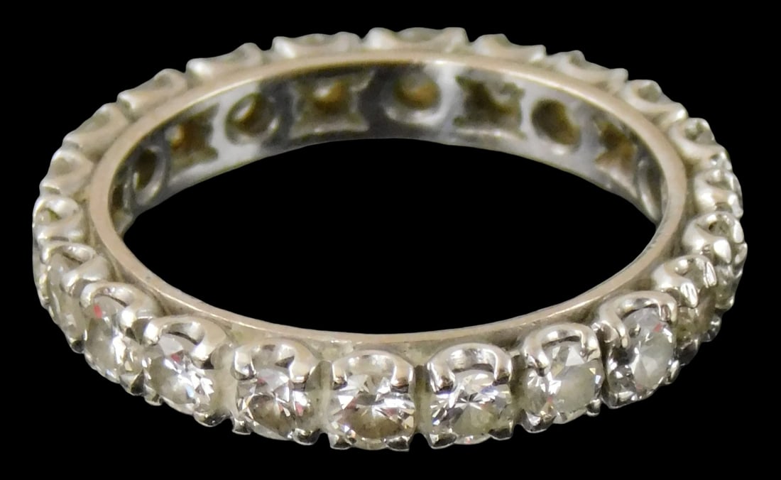 JEWELRY: 14K White gold and diamond eternity band, tested, four-prong settings, set with twenty-two (1 of 3)