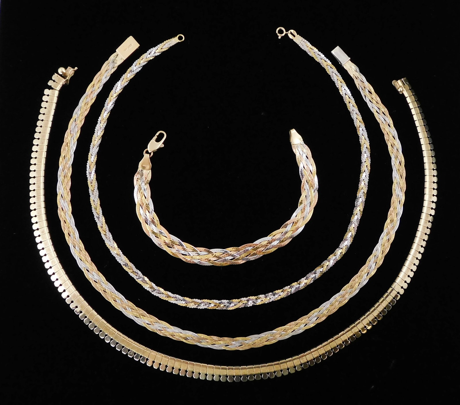JEWELRY: Two 14K braided herringbone necklaces and one 14K bracelet, all stamped and tested “: JEWELRY: Two 14K braided herringbone necklaces and one 14K bracelet, all stamped and tested “14K”, braided design of yellow, white and rose gold, longest: 16" l., bracelet: 7 1/4" l. [Tota