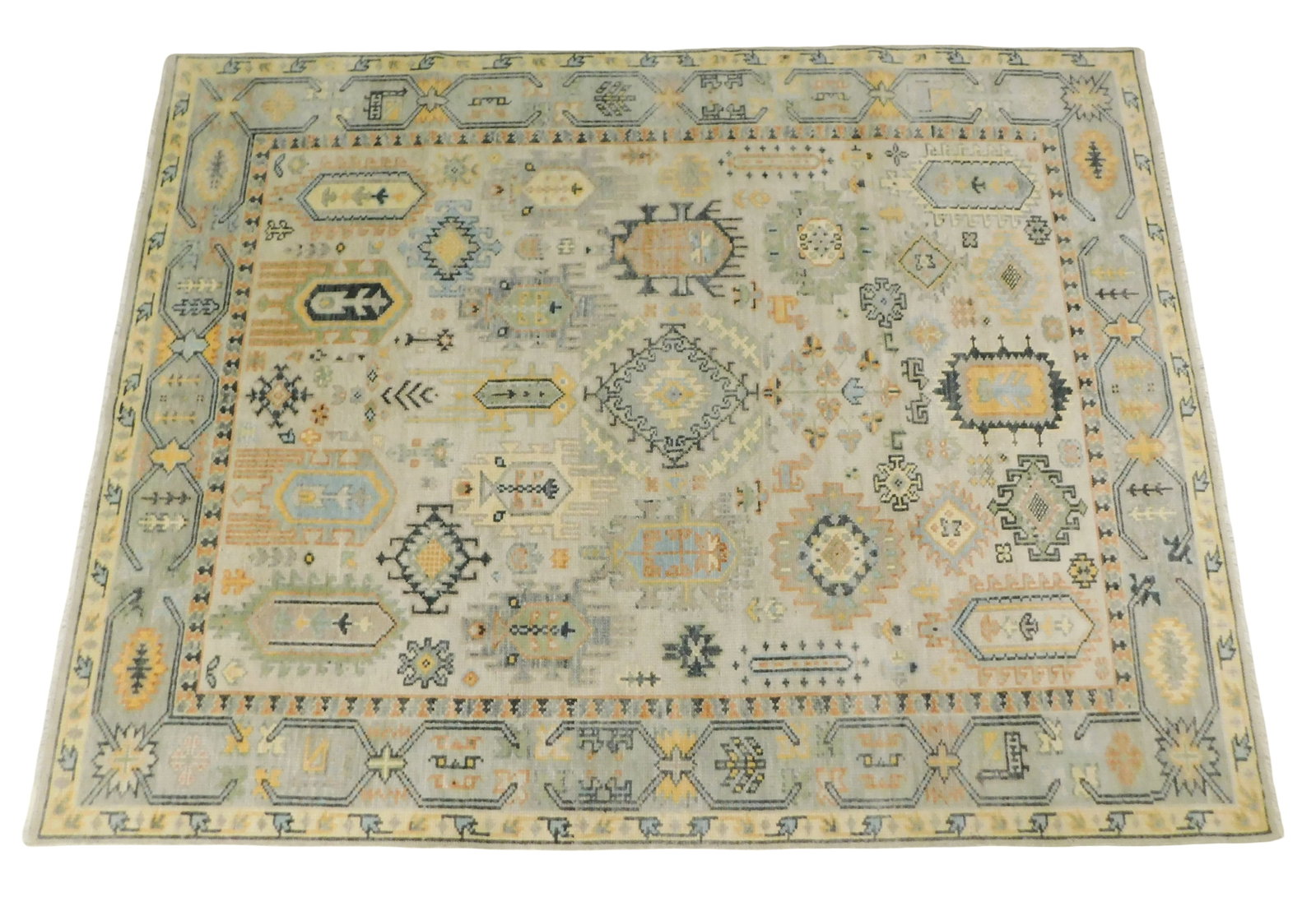RUG: Laristan Karajeh, 7' 8" x 10' 1", wool on cotton, light gray ground, accents of navy, pumpkin,: RUG: Laristan Karajeh, 7' 8" x 10' 1", wool on cotton, light gray ground, accents of navy, pumpkin, off white, etc., repeating geometrical patterns and various medallions, wear consistent with age and