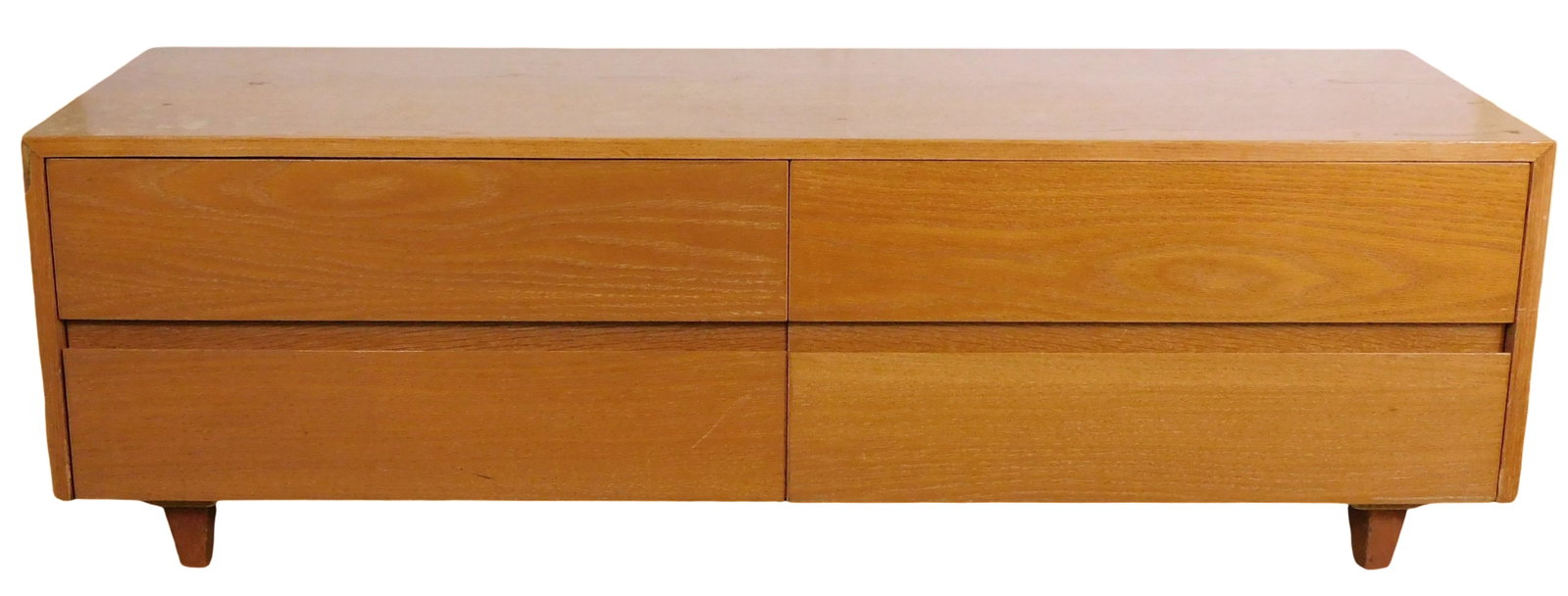 Mid-century modern low chest of drawers, mid to late 20th C., blonde finish, two stacks of two long: Mid-century modern low chest of drawers, mid to late 20th C., blonde finish, two stacks of two long drawers, raised on four tapered feet on metal slides, no maker's mark viewed, chipped edge to frame,