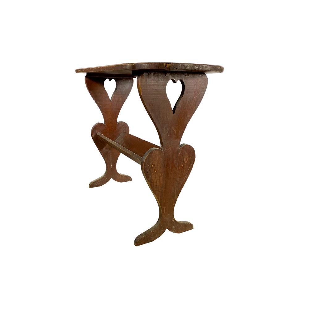 Folk Art Library Table With Heart Motif: Library table of trestle form having a rectangular top with 'D' ends above a 'V' shaped book trough joining the two legs. Each leg in the form of two hearts, one above the other, and the top one havin