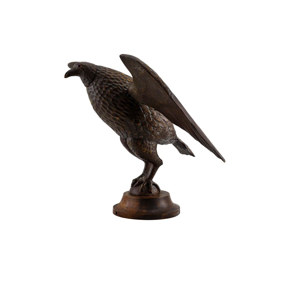 Folky Carved and Painted Bird on Stand: With outstretched wings, talons clutching a sphere and putty painted with dark brown paint with glass eyes, mounted on its original pedestal. Found in Tioga, PA., c .1940. 14.5" H x 17" L x 15" D some