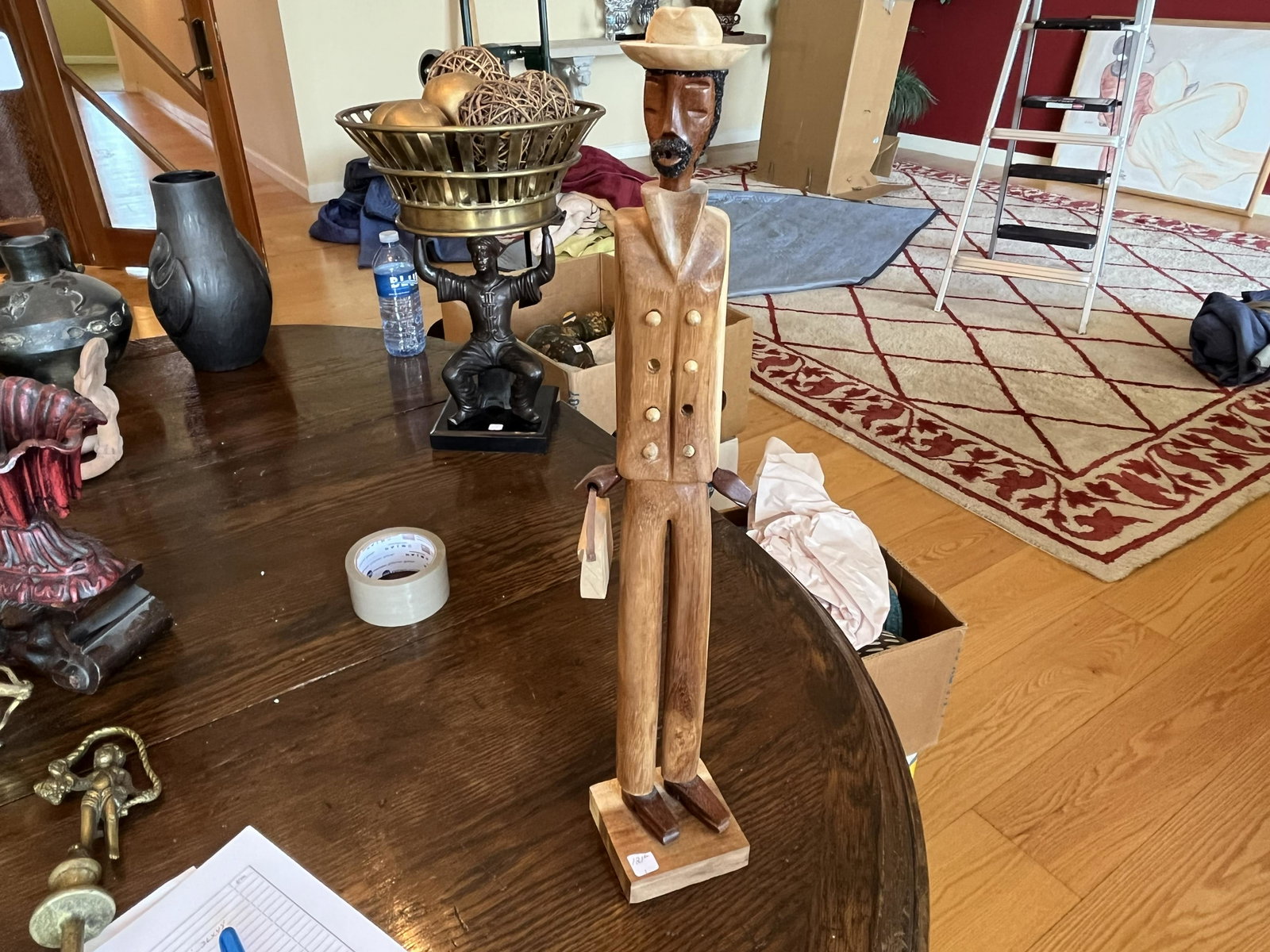Wood Carving of a Man Carrying a Purse: Wood Carving of a Man Carrying a Purse, 21"h