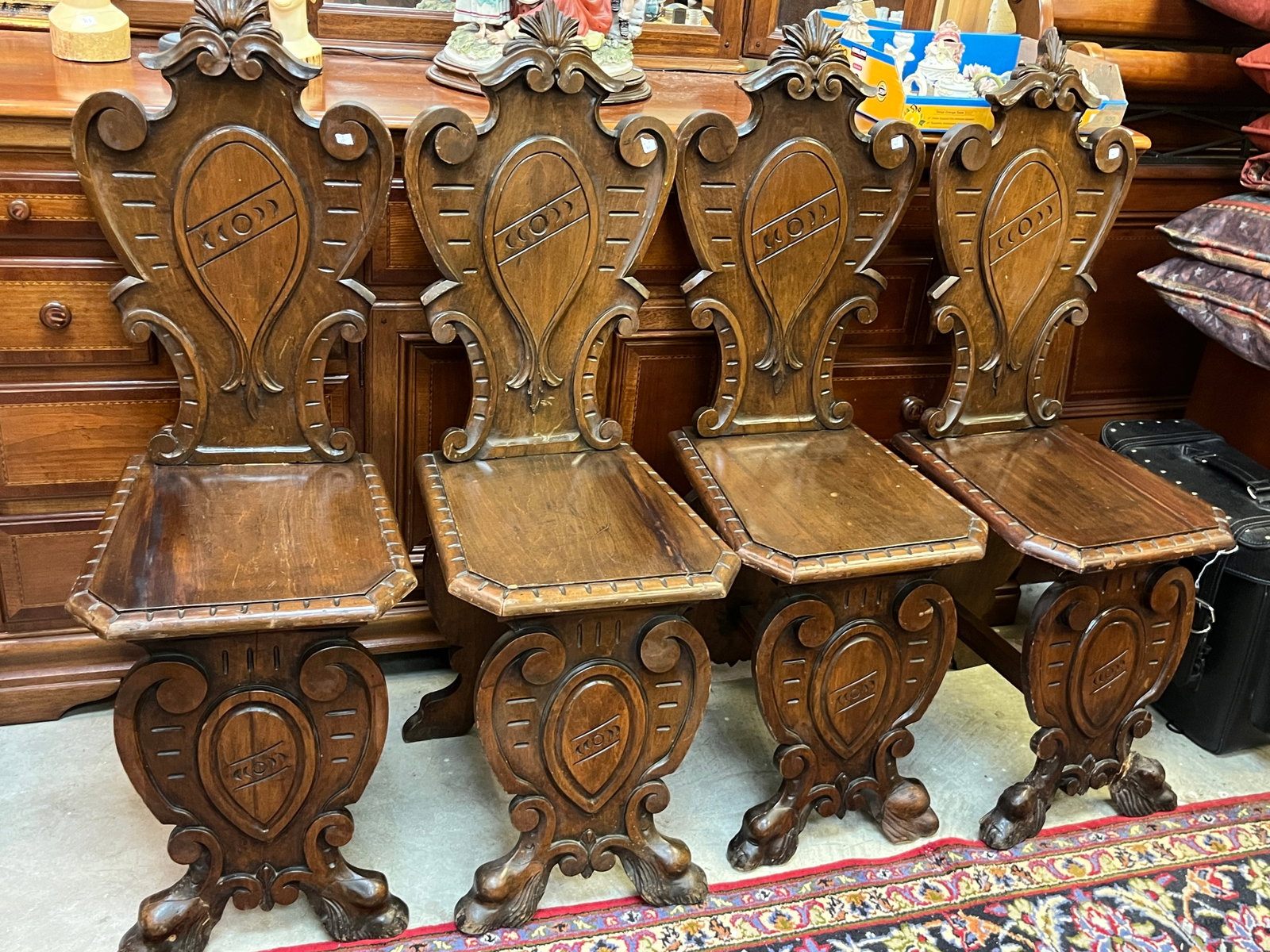 4-Italian Sgabello Hall Chairs: (4) Carved Italian Walnut Sgabello Hall Chairs 19th c. (1-has damaged foot)