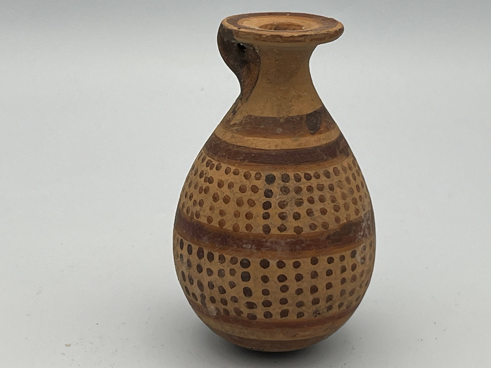 Etrusco-Corinthian Piriform Alabastron: Etrusco-Corinthian Piriform Alabastron, Magna Graecia ca.6th century BCE, 3.5h(8.8cm) Terracotta Inscribed Alabastron (Perfume Vase) - Etruscan, Etrusco-Corinthian (ca. 600 BCE): Another example is an