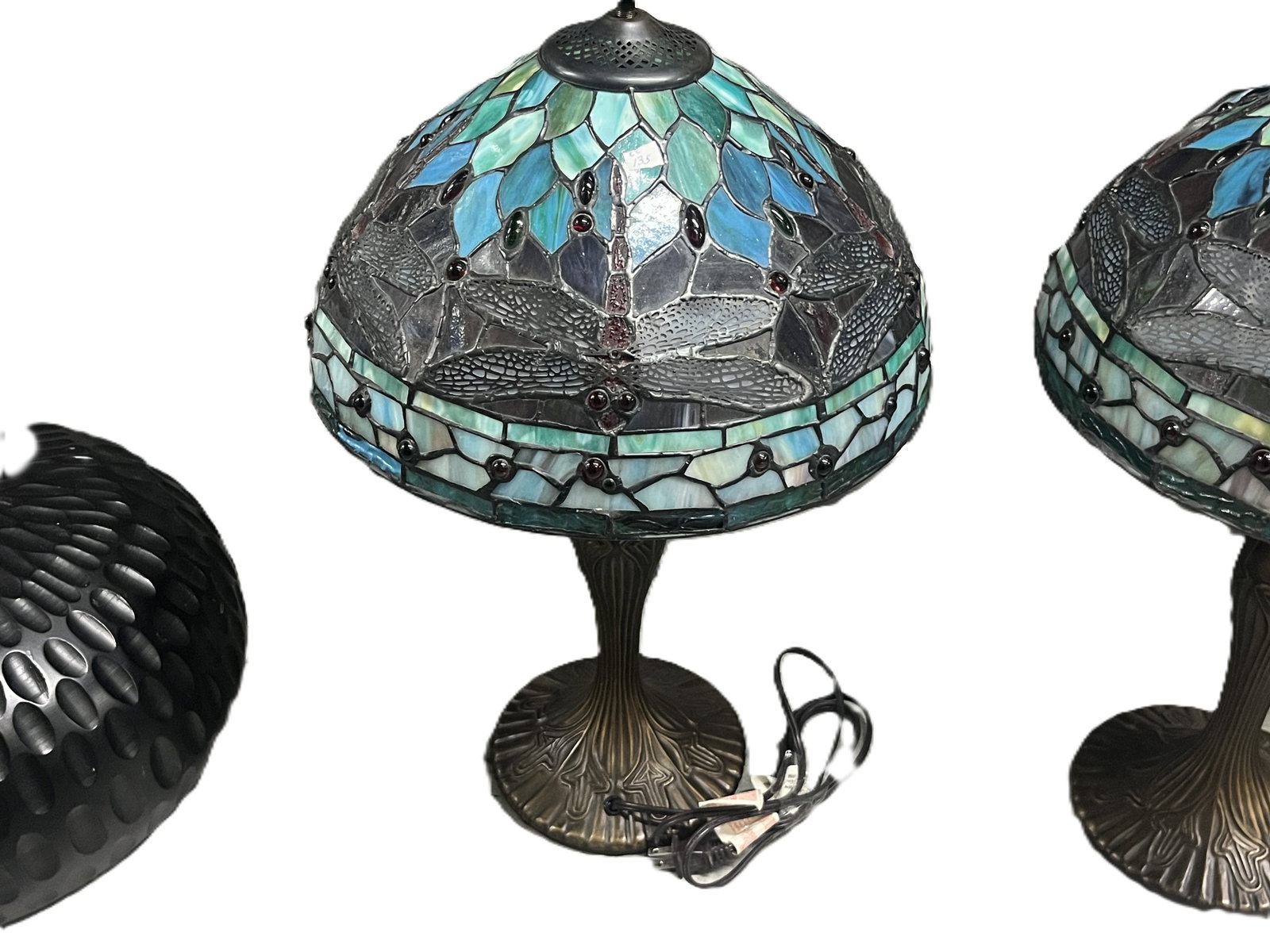 Tiffany‑Style “Dragonfly” Stained Glass Table Lamp — Blue and Green Leaded: A decorative table lamp featuring a Tiffany‑style stained glass shade with a dragonfly motif, composed of hand‑cut pieces of blue, teal, and green glass accented by jewel‑tone caboch